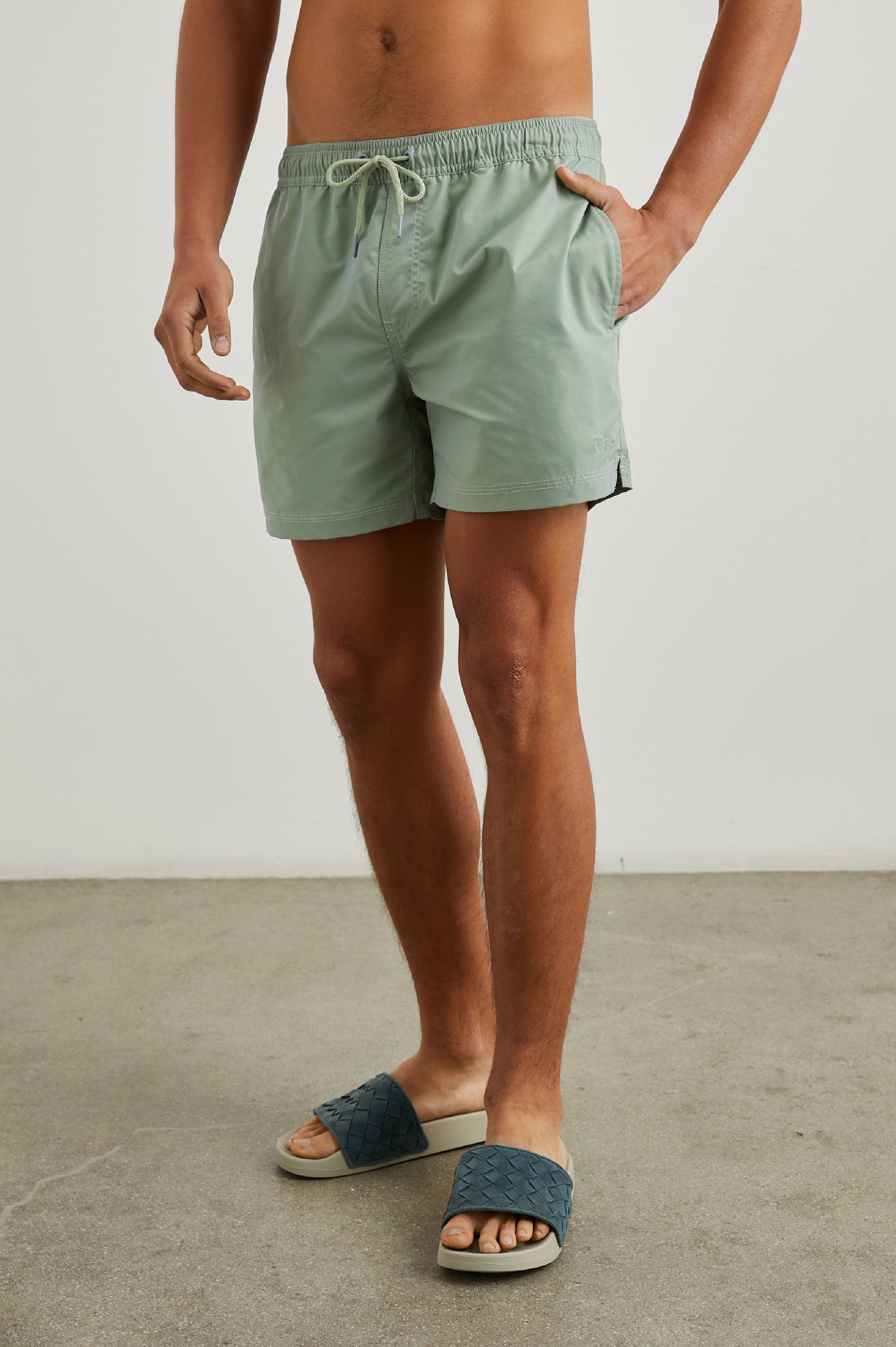 La Brea Swim Shorts with a Drawstring Waist, Two Front Pockets and a Back Patch Pocket in Tea Leaf Colorway - Front View Featured on Model