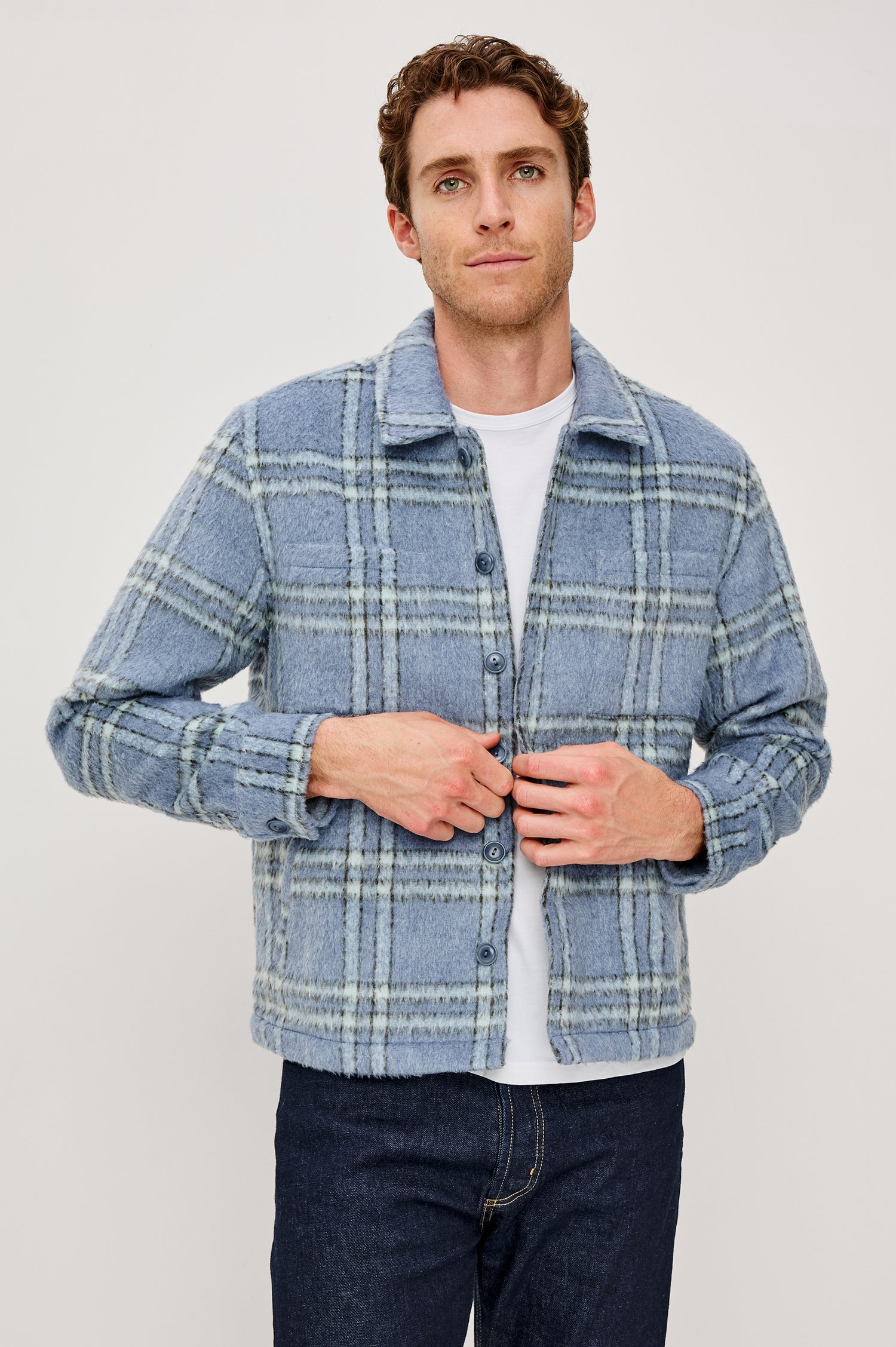 Lachlan is a fully lined shirt jacket with a classic collar, front buttons, chest patch pockets in Blue Lotus colorway. Front view featured on model.