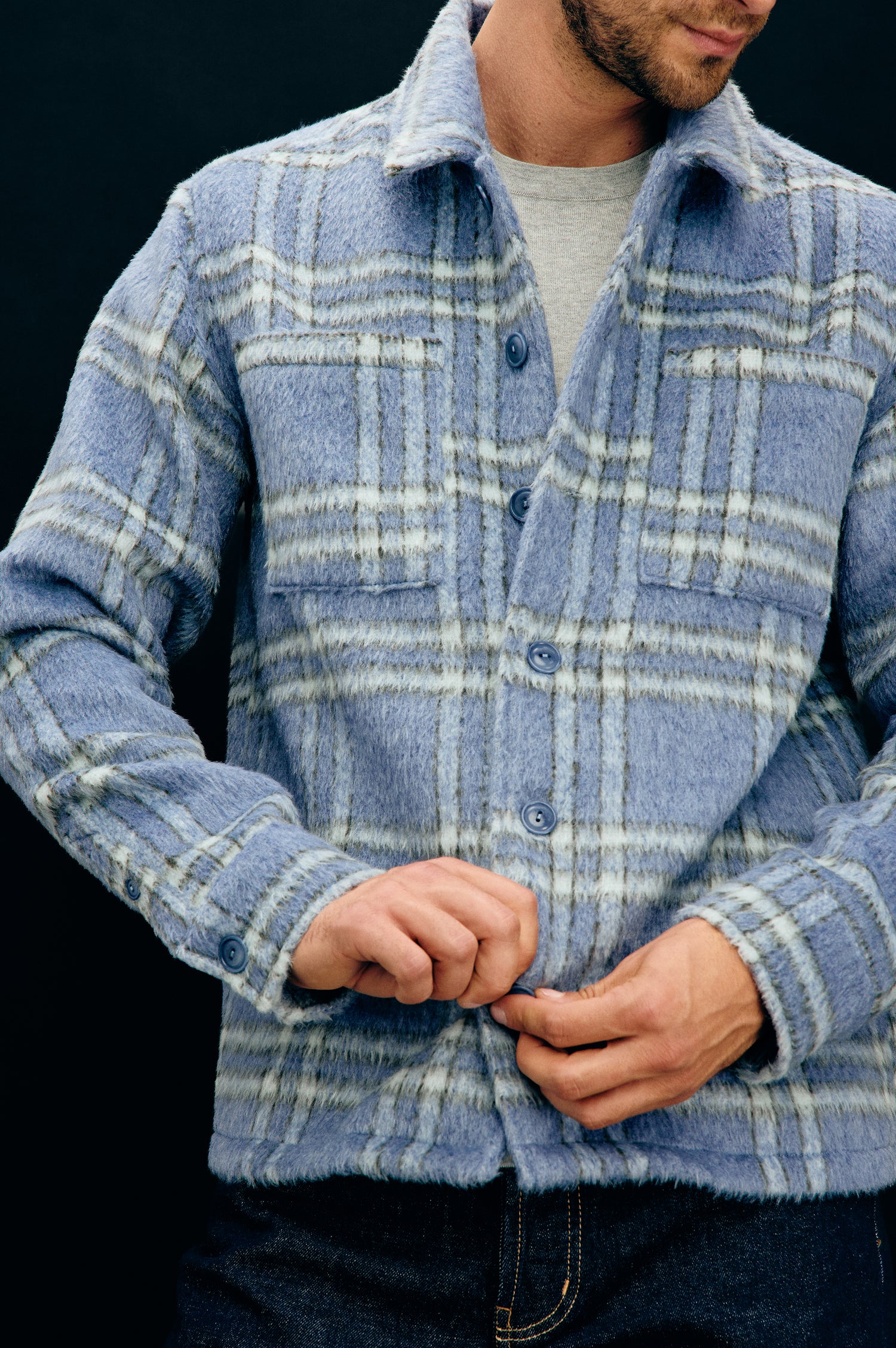 Lachlan is a fully lined shirt jacket with a classic collar, front buttons, chest patch pockets in Blue Lotus colorway. Front detail view featured on model.