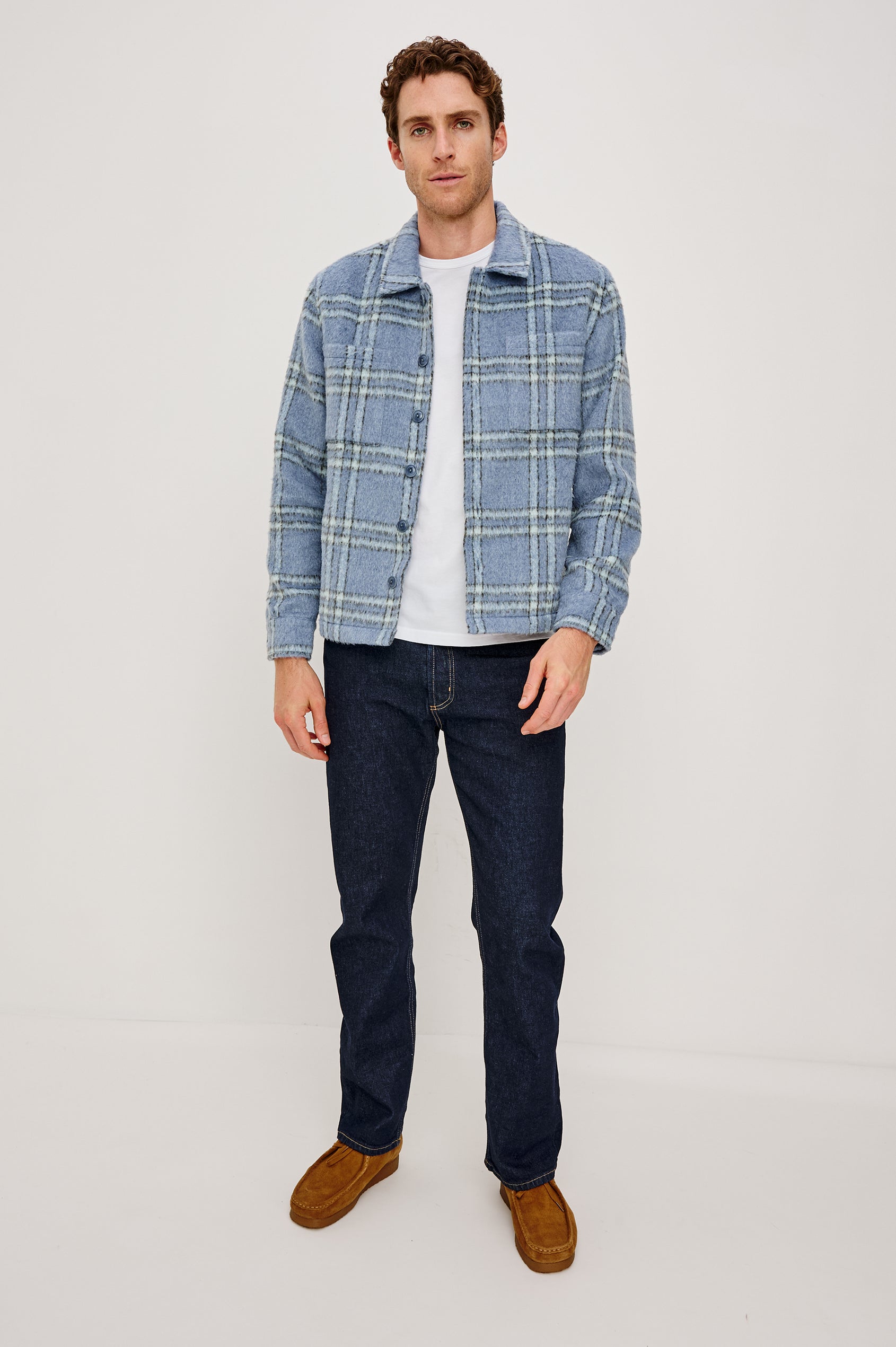 Lachlan is a fully lined shirt jacket with a classic collar, front buttons, chest patch pockets in Blue Lotus colorway. Front full body view featured on model.