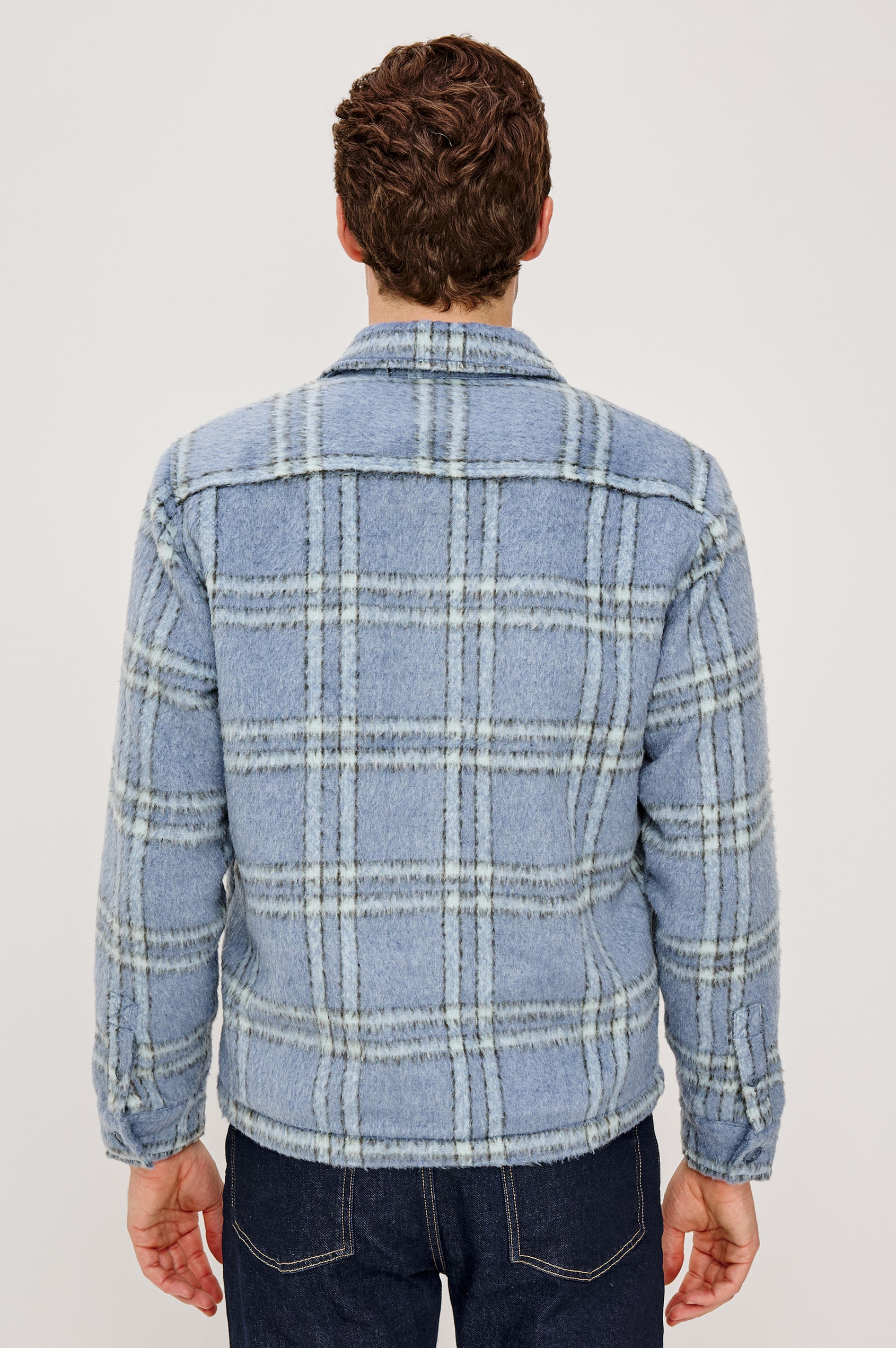 Lachlan is a fully lined shirt jacket with a classic collar, front buttons, chest patch pockets in Blue Lotus colorway. Back view featured on model.