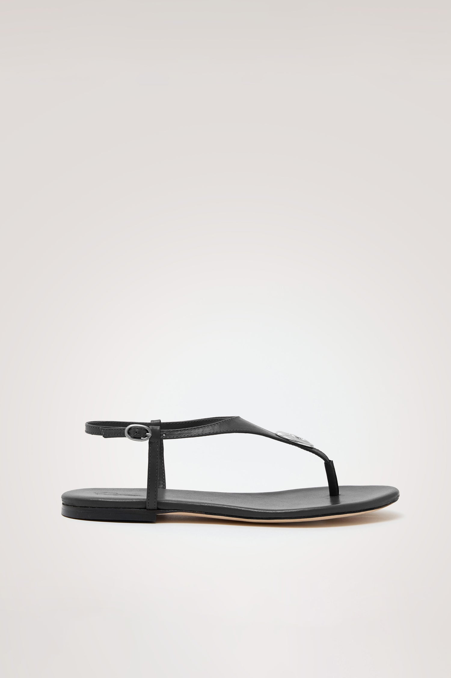 Lagos T-Strap Sandal in Leather With Adjustable Buckled Ankle Straps and Molded Silver Hardware Detail in Black Colorway - Side View Featured
