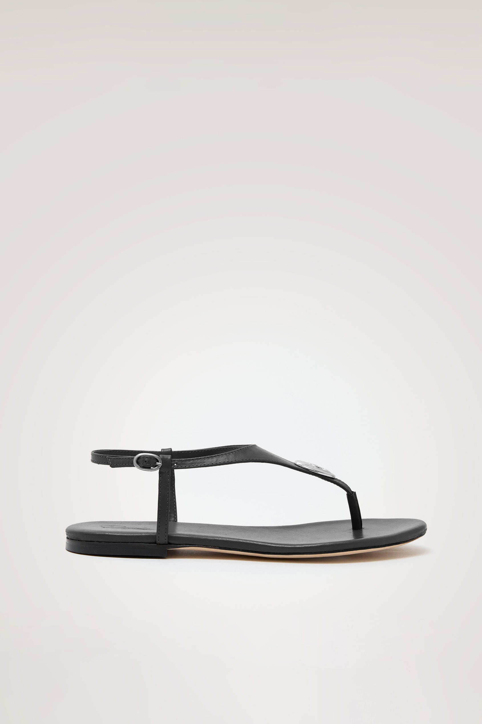 Lagos T-Strap Sandal in Leather With Adjustable Buckled Ankle Straps and Molded Silver Hardware Detail in Black Colorway - Side View Featured