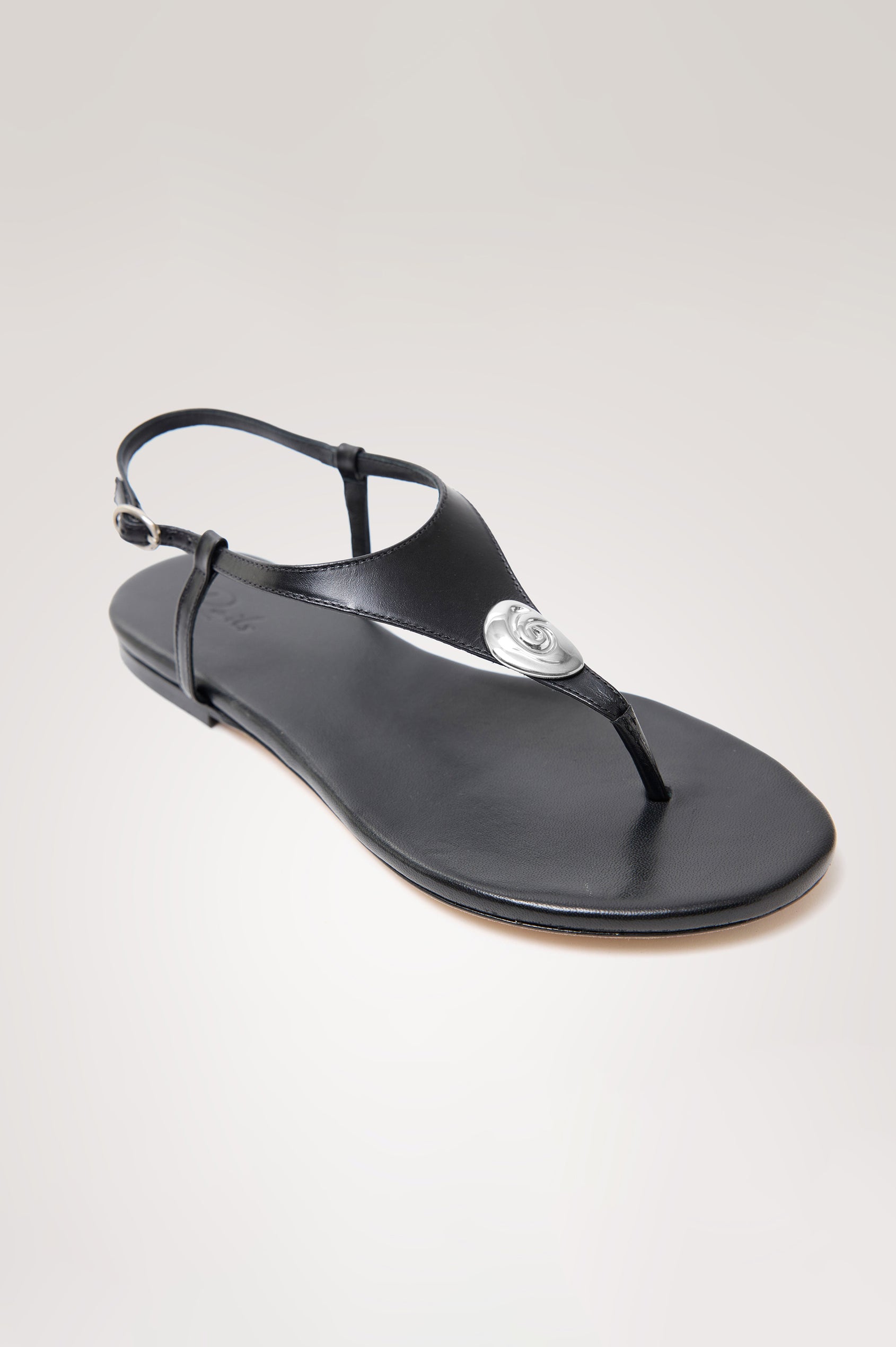 Lagos T-Strap Sandal in Leather With Adjustable Buckled Ankle Straps and Molded Silver Hardware Detail in Black Colorway - Side View Featured
