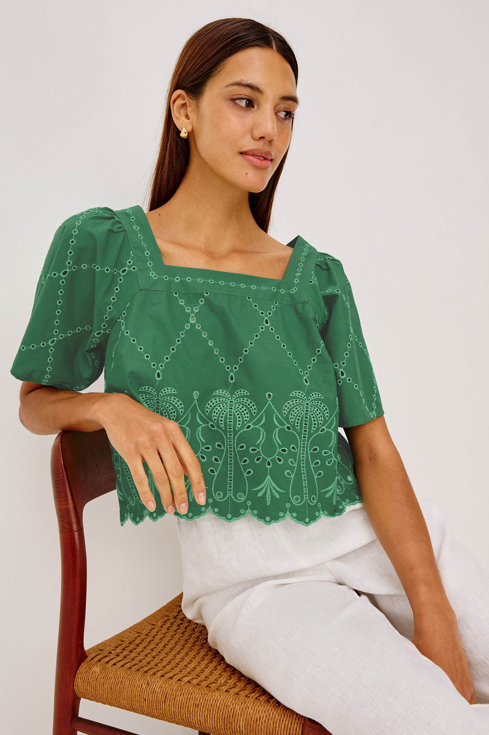 Laine Crop Top in Cotton Poplin With Boxy Fit, Square Neckline, Wide Short Sleeves, Embroidered Details, and Scallop Hem in Clover Colorway - Upper Body View Featured on Model Sitting