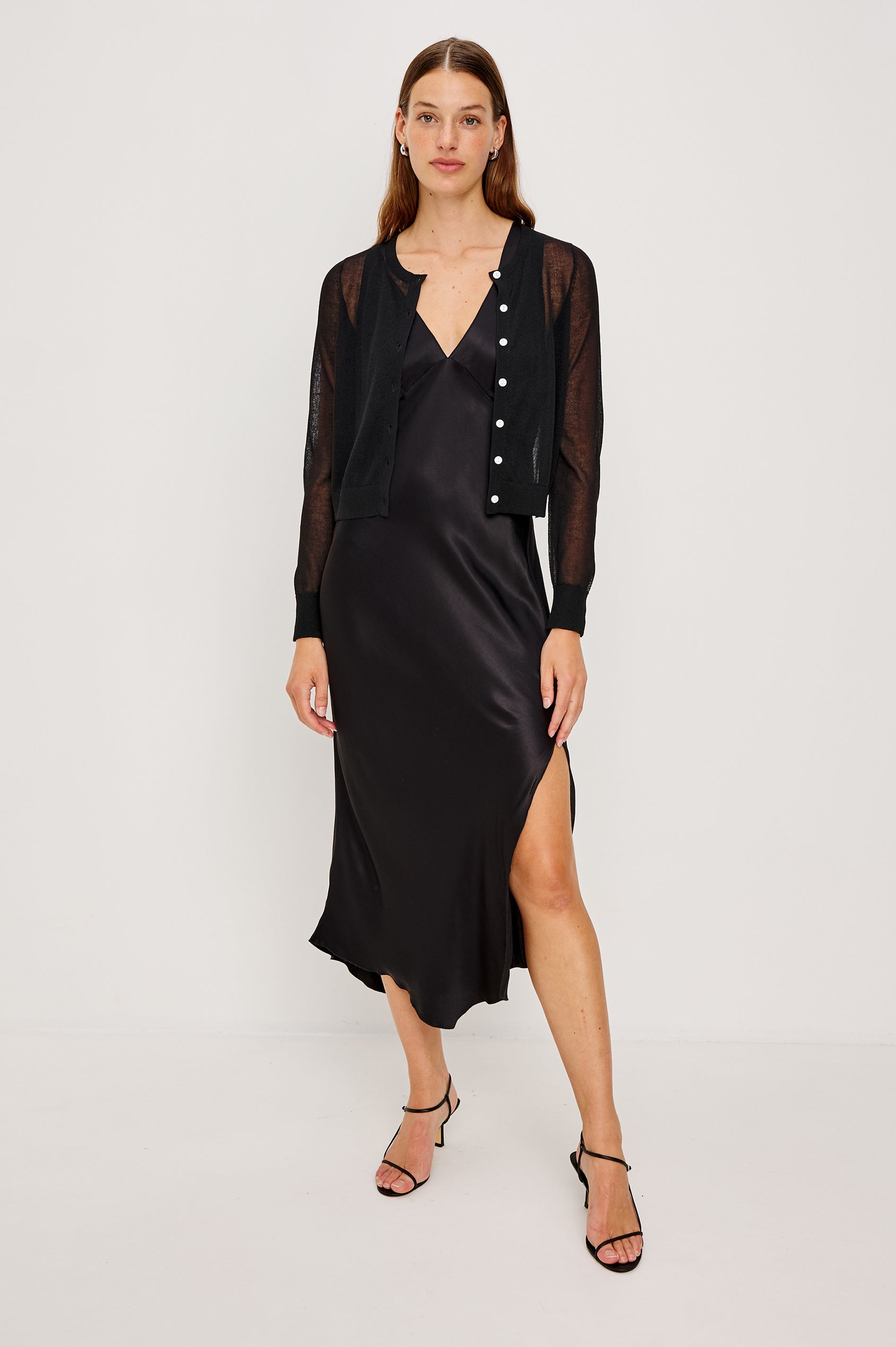 Lakelyn is a sheer button front cardigan with ribbed trim in black colorway. Front full body view featured on model.