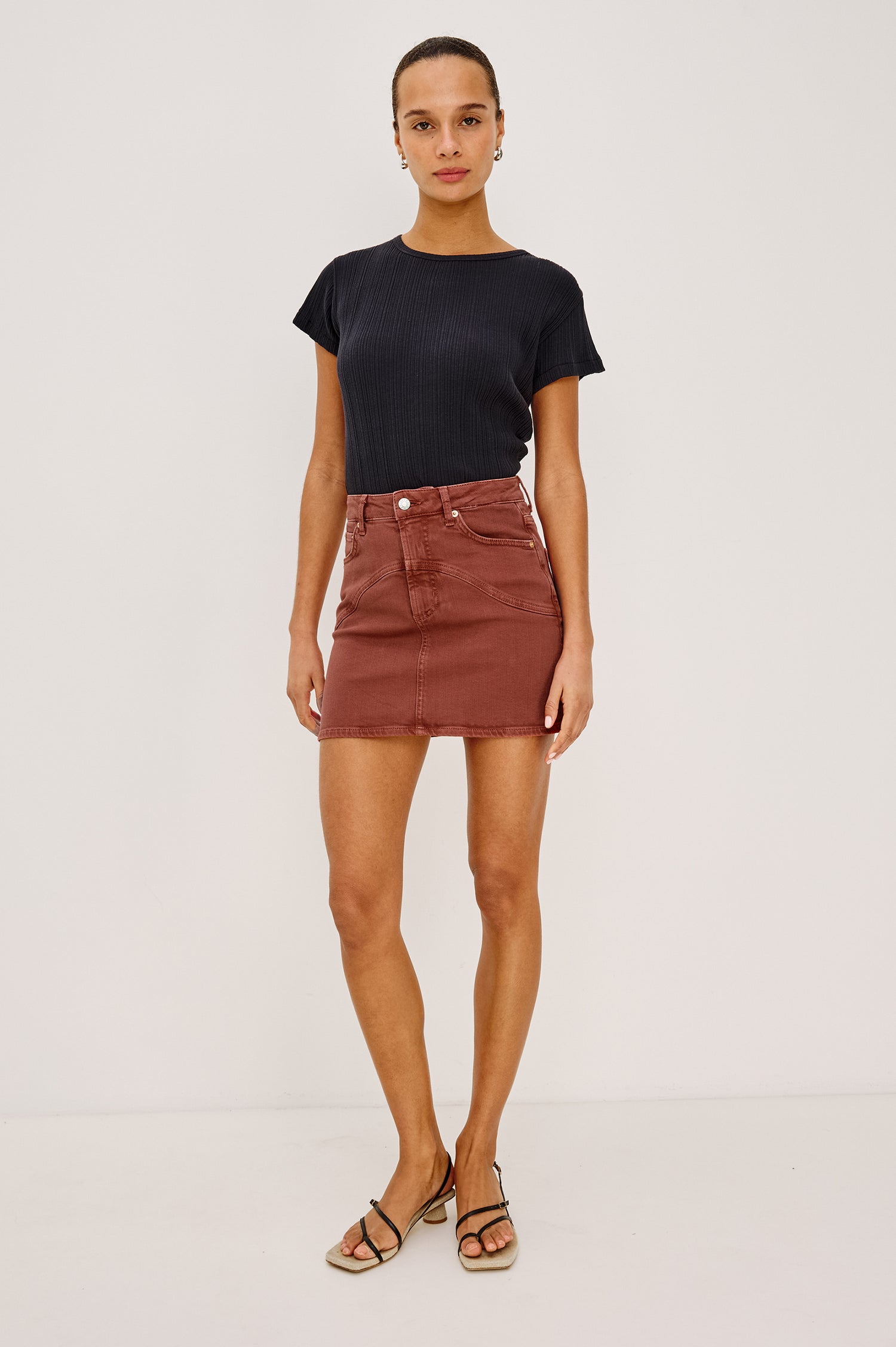 Lockwood Mini Skirt in Denim With Yoke Seam Detailing, Zip Fly, and Pockets in Vintage Brick Colorway - Full Body Front Close Up View Featured on Model