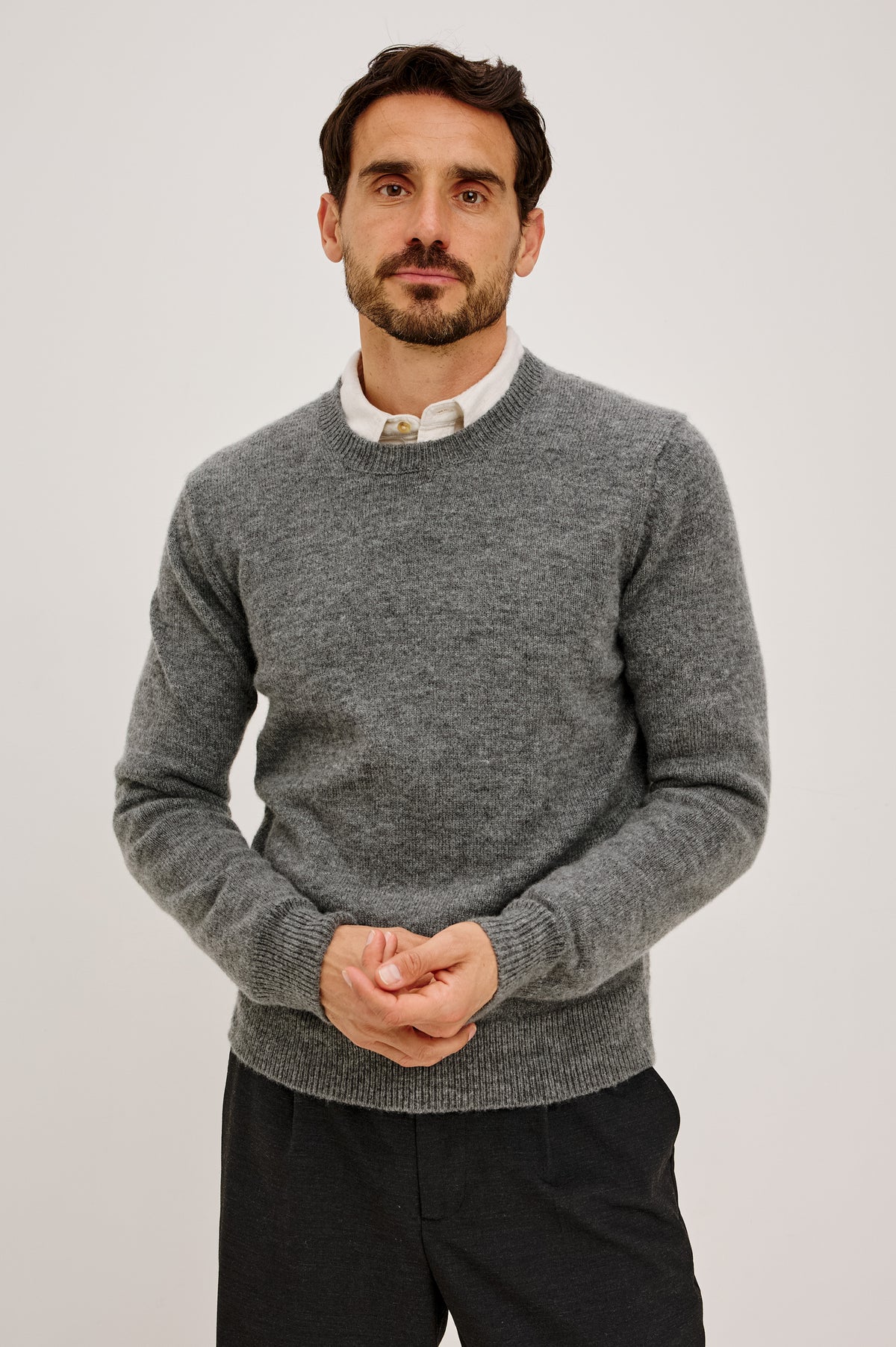 Laurent Sweater in Wool Blend With Crewneck, Dropped Shoulders, Linked Stitch Detailing, and Long Sleeves in Charcoal Colorway - Upper Body Front View Featured on Model
