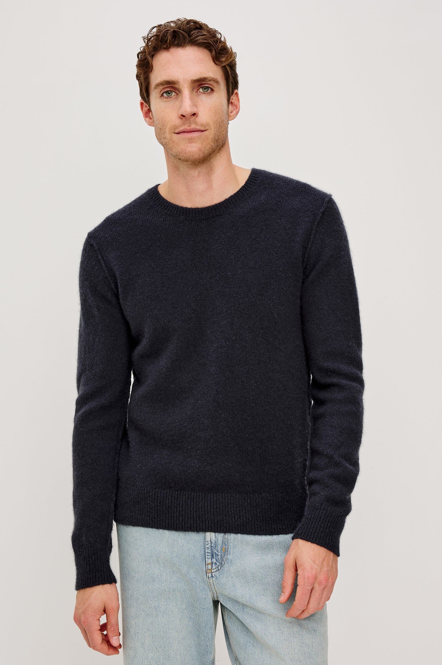 Lars Crewneck Sweater in Merino Wool Blend With Relaxed Fit, Long Sleeves, Fairisle Motifs, Long Sleeves, and Ribbed Trim - Full Body View Featured on Model Sitting