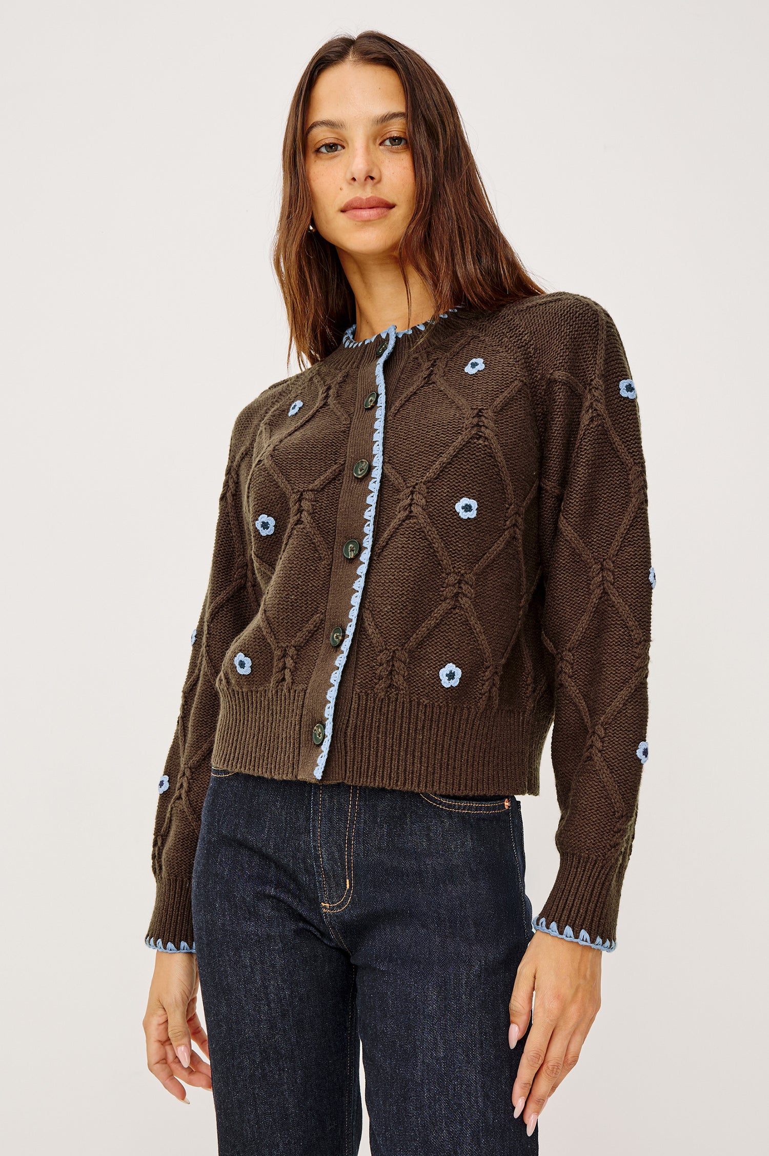 Laurie Cardigan in Cable Knit With Diamond Detailing, Floral Embroidery, Contrast Blanket Stitching, Front Buttons, Long Sleeves, and Ribbed Trim in Walnut Daisy Colorway - Upper Body Front View Featured on Model