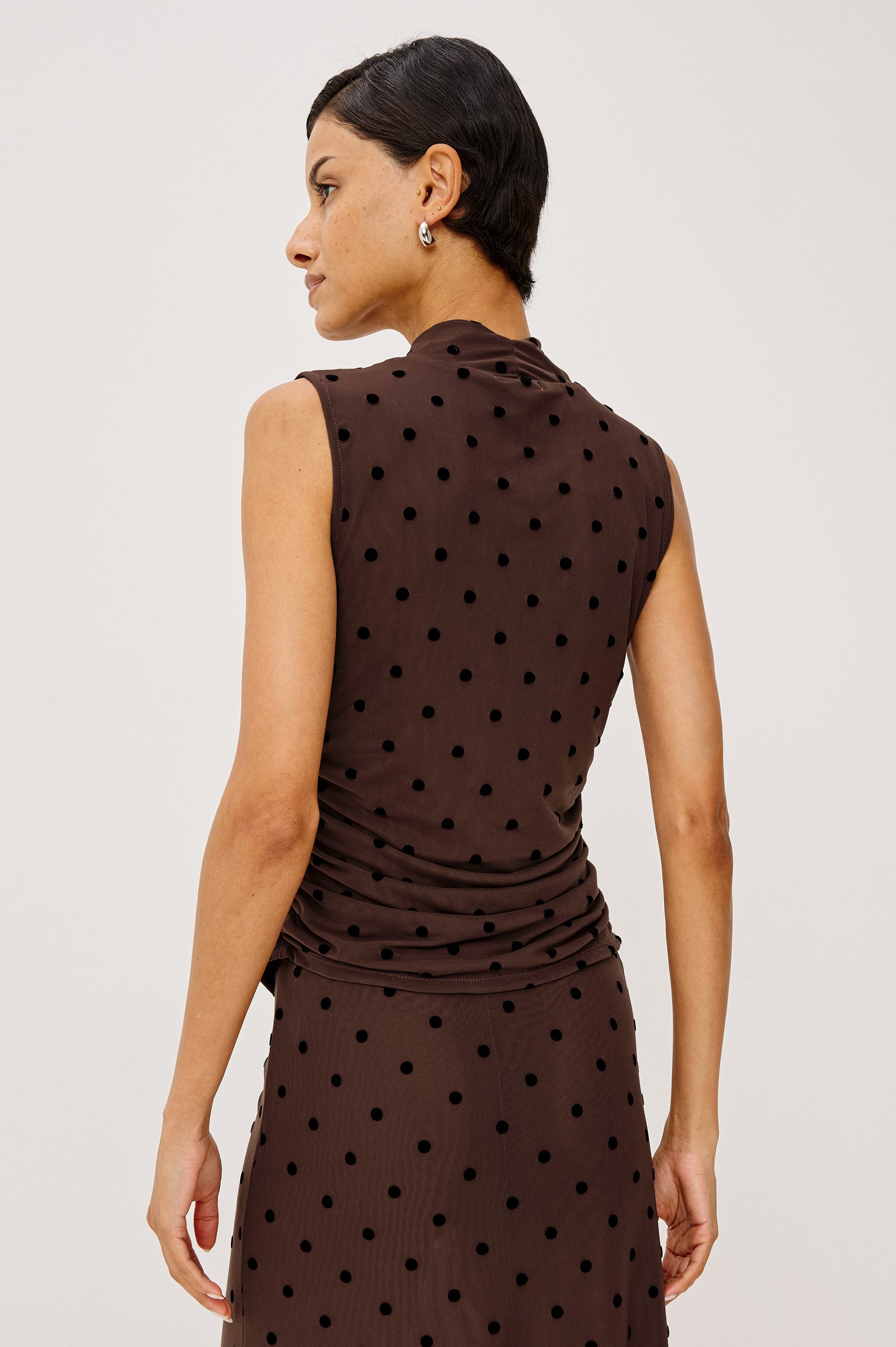 Lauris Top in Stretch Mesh With Wrap Neckline, Side Ruching, and Velvet Flocked Motifs in Chocolate Polka Dot Colorway - Upper Body Back View Featured on Model