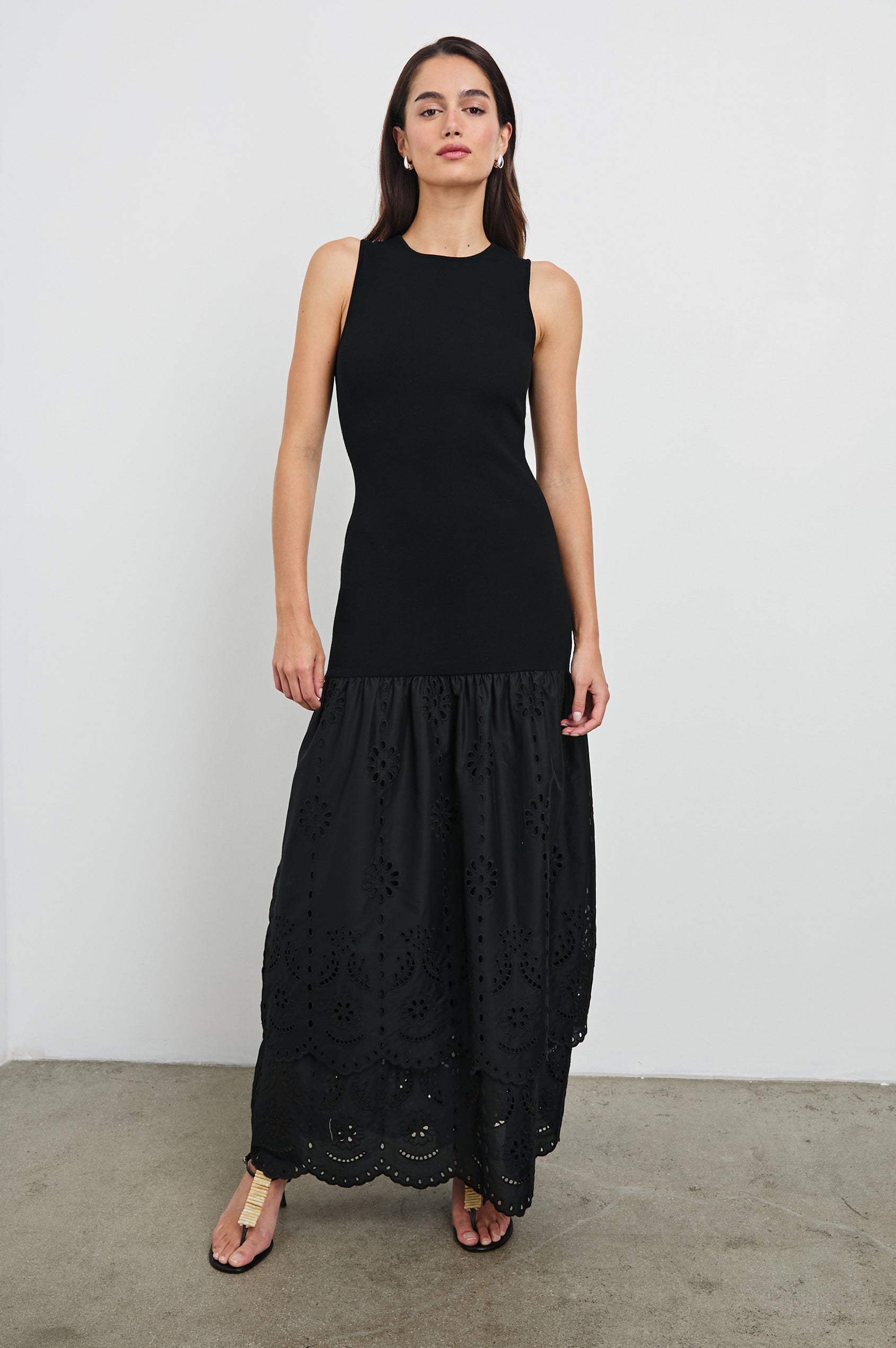 Lavina Crew Neck Tank Maxi Dress with Body Con Fitted Top Half and an Gathered Contrast Fabric Skirt with Embroidered Scallop Two Tier Hem in Black Colorway. Front View Shown on Model.