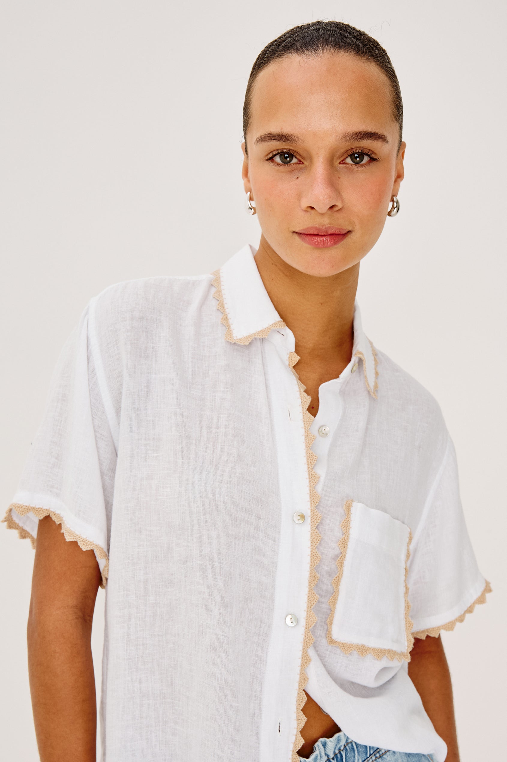 Lea Top in Luxe Linen With Relaxed Fit, Split V-Neck, Crochet Trim, and Flutter Sleeves With Natural Crochet Colorway - Upper Body Close Up Front View Featured on Model