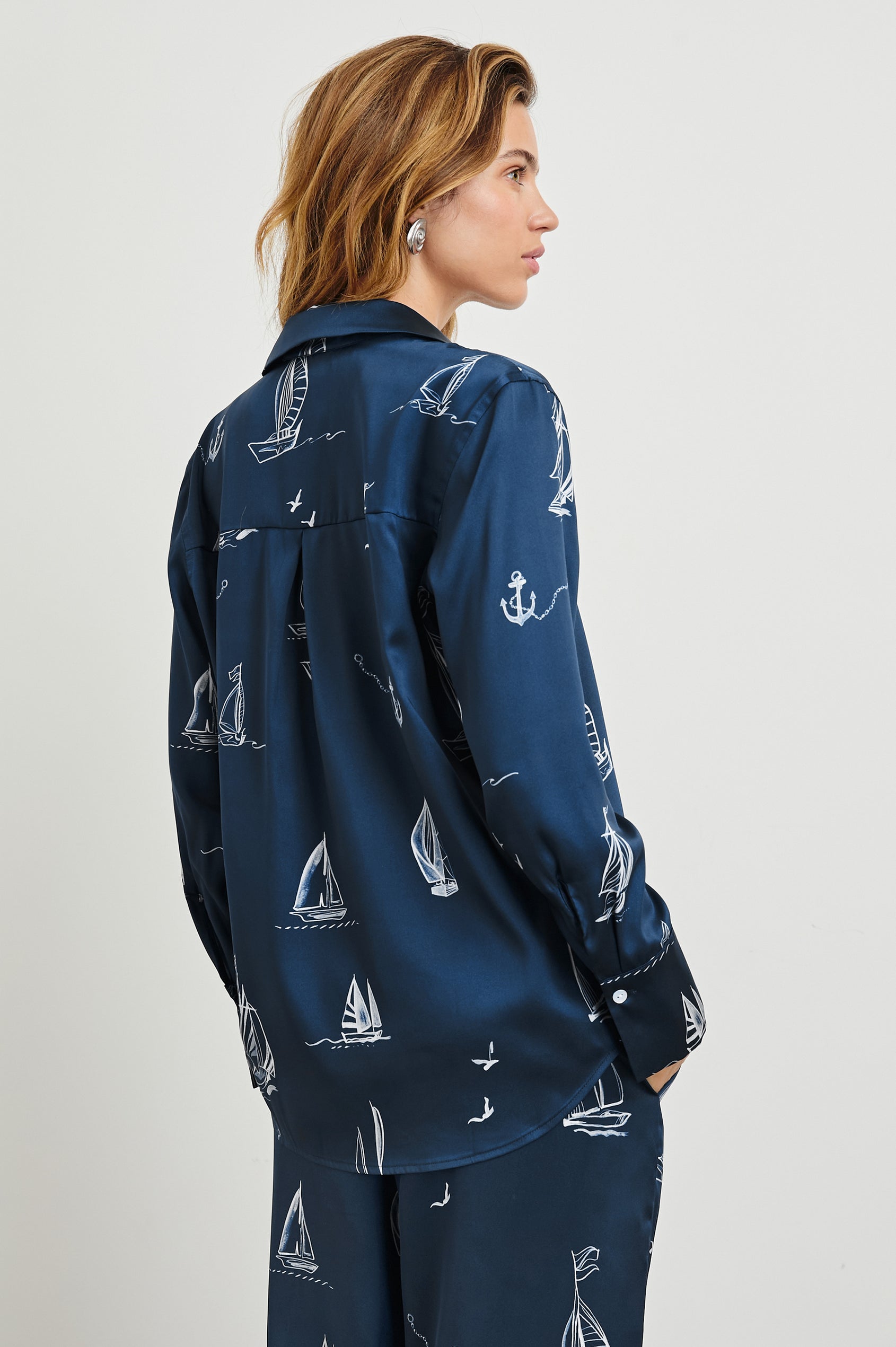 Ledger Long-Sleeve Button Down in Sailboats Colorway, with white sailboats on dark blue - Back View Featured on Model
