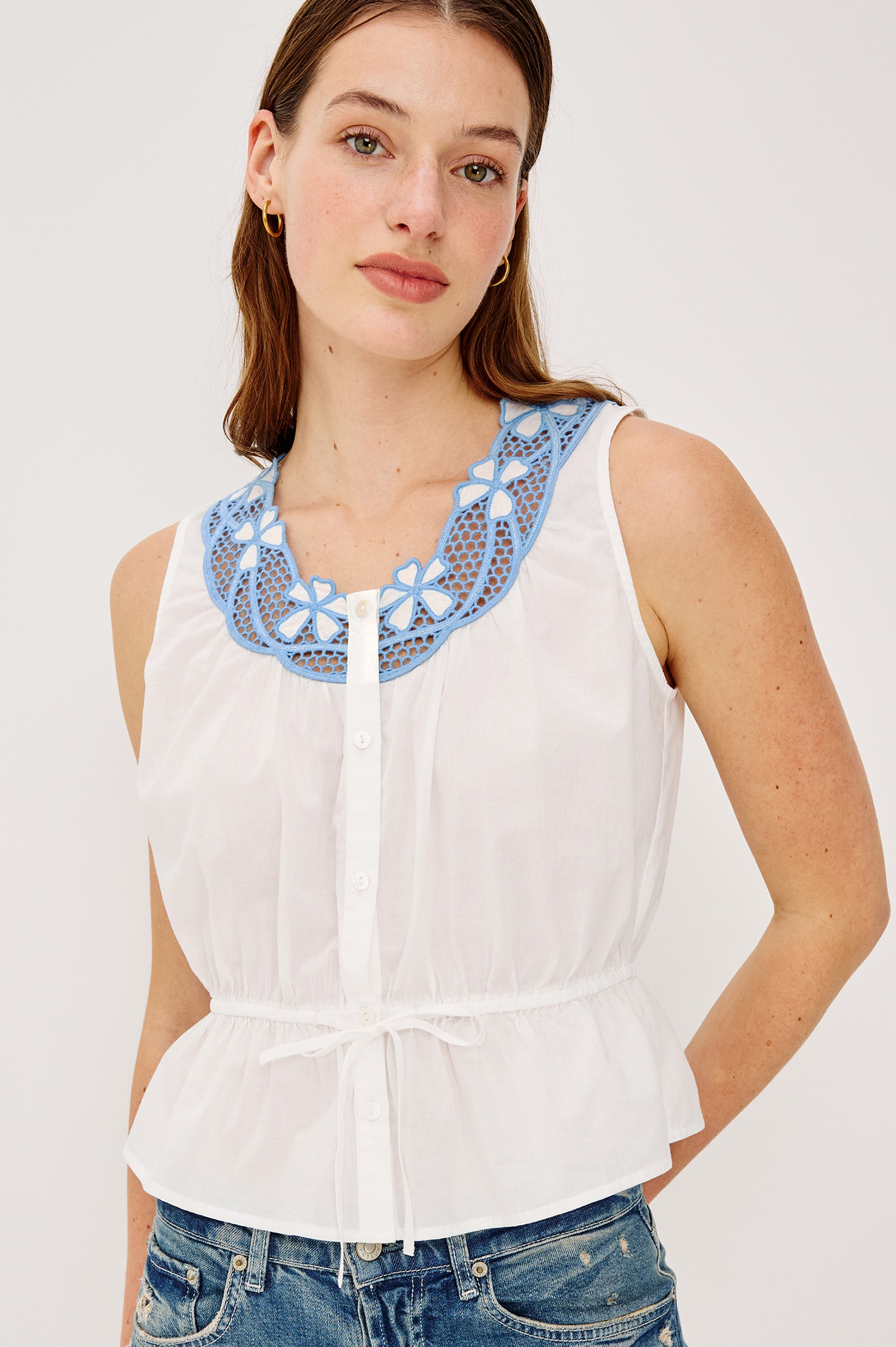 Leilani Top in Lightweight Beach Cotton With Scoop Neckline Contrast Lattice Embroidery Front Buttons Relaxed Fit and Adjustable Waist Ties in White Colorway - Upper Body Front View Featured on Model