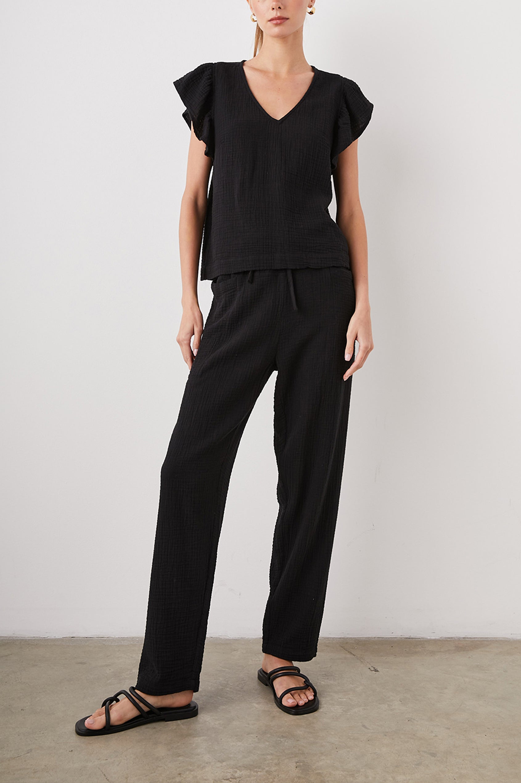 Lela Short-Sleeve Top with Flutter Sleeves and a V Neck in Black Colorway - Front Full Body View Featured on Model  