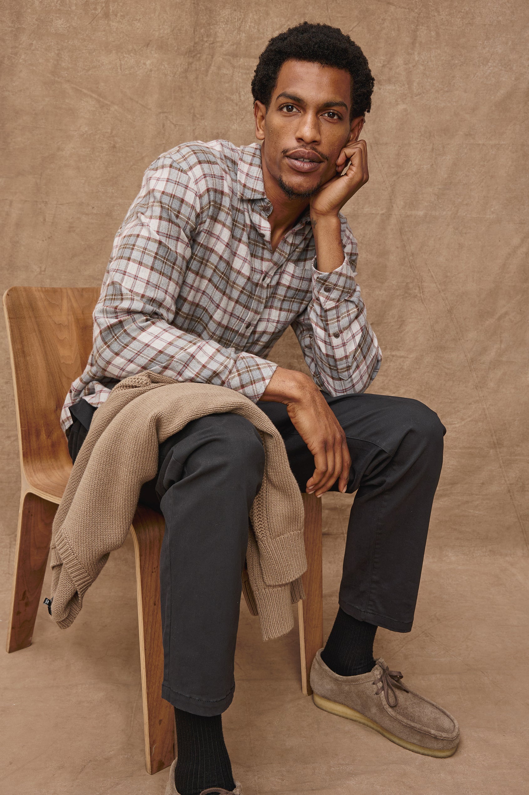 Lennox Long-Sleeve Button Up with a Chest Patch Pocket in Charcoal Autumn Melange Colorway, a plaid in Charcoal, Burnt Orange and White - Front Seated View Featured on model