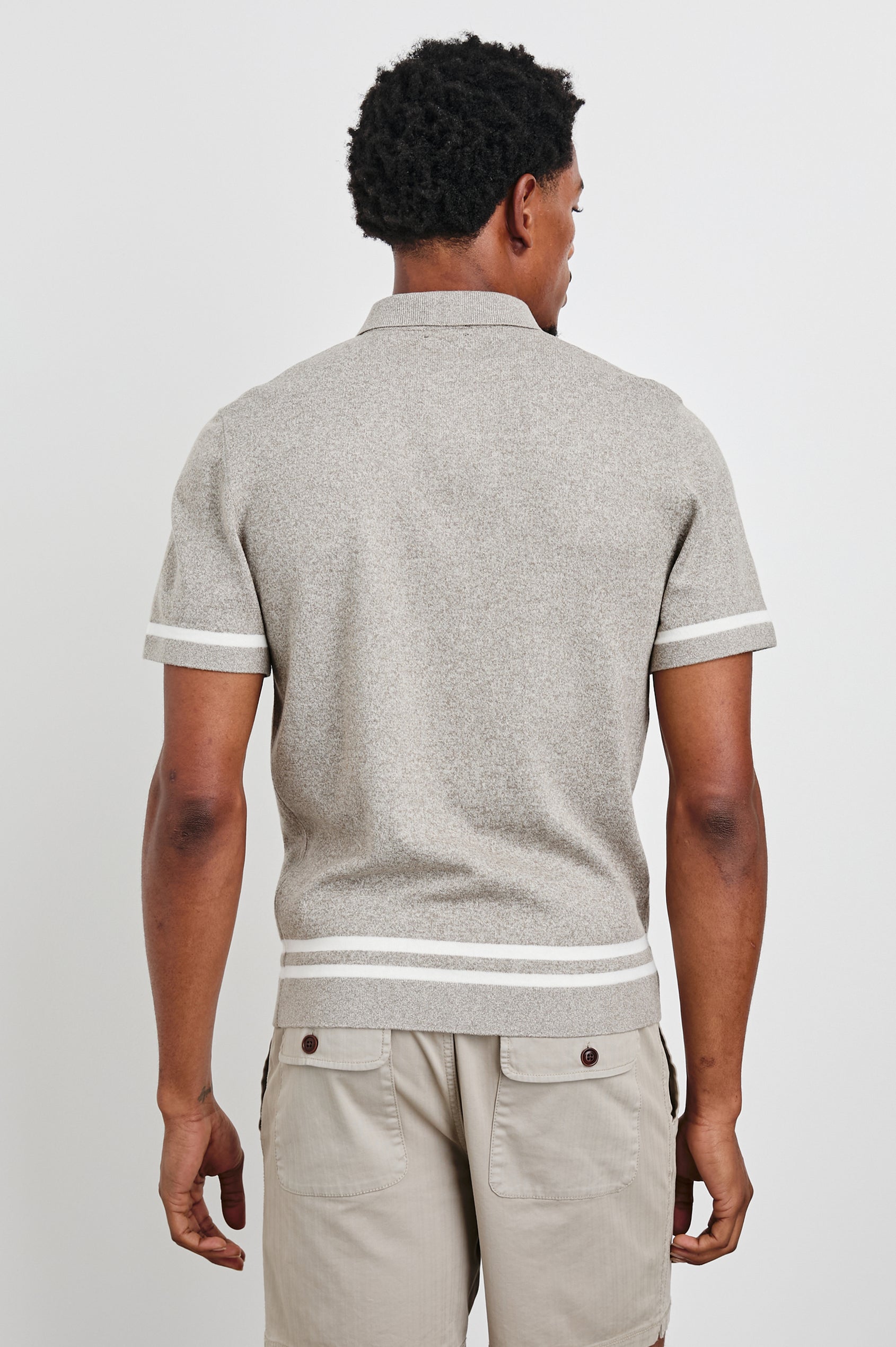Leo Short-Sleeve Button Up in Oat Grey Melange Colorway, with white bands along the buttons and trim - Back View Featured on Model