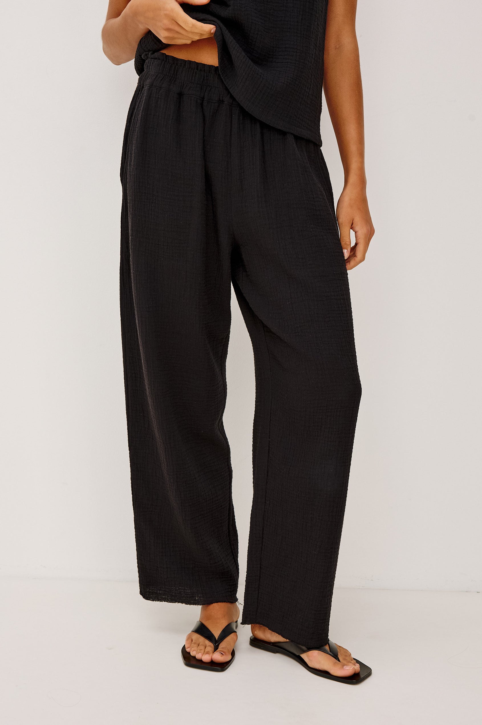Leon Crop Cotton Gauze Pant With Hemline Slit And Elastic Waist In Colorway Black - Front View Featured On Model