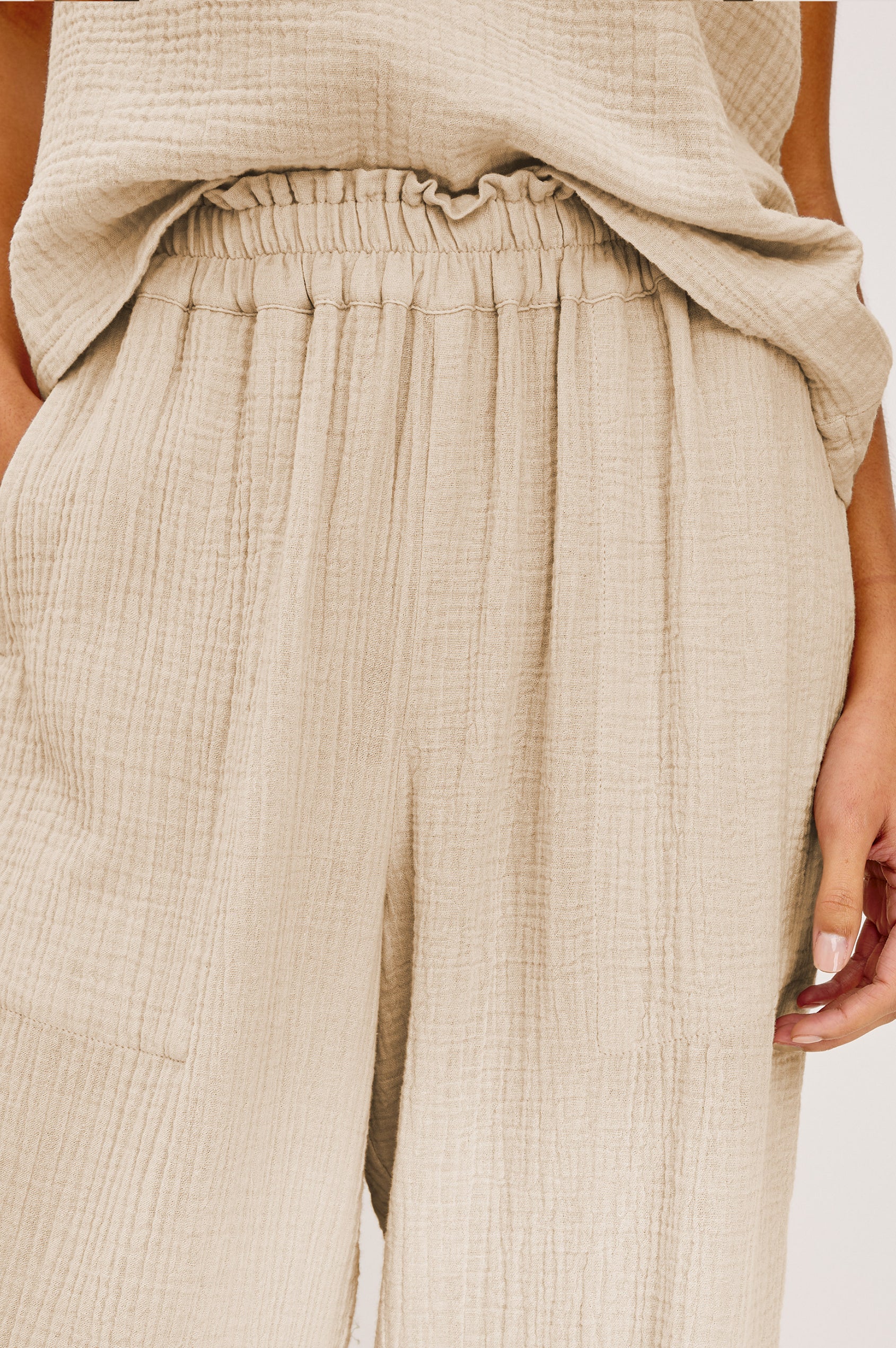 Leon Crop Pant with a Smocked Waistband and Two Front Seam Pockets in Light Brown Heather Flax Colorway - Lower Body Front View Zoomed In Details Featured on Model