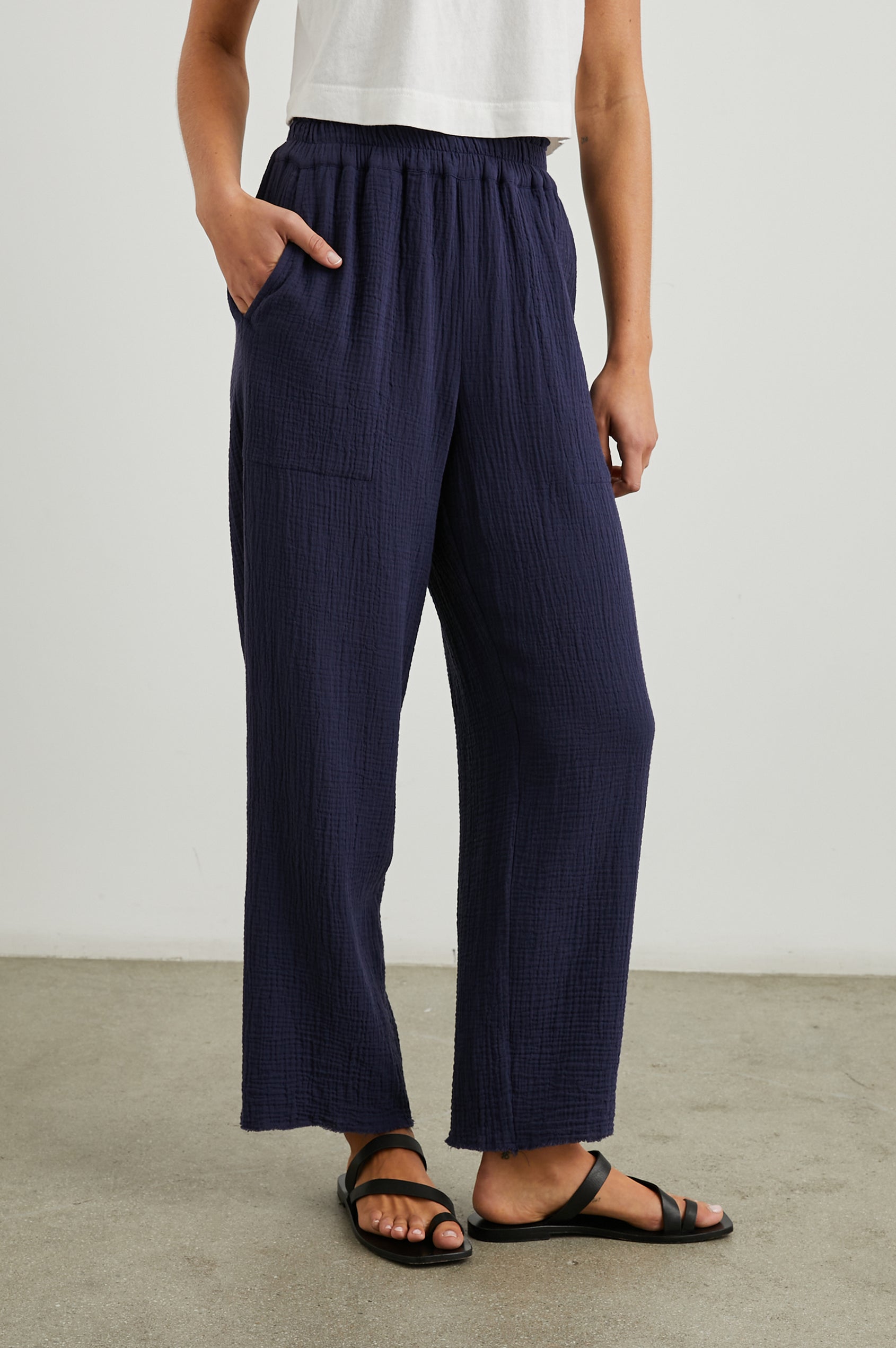 Leon Crop Pant with a Smocked Waistband and Two Front Seam Pockets in Navy Colorway - Front View Featured on Model