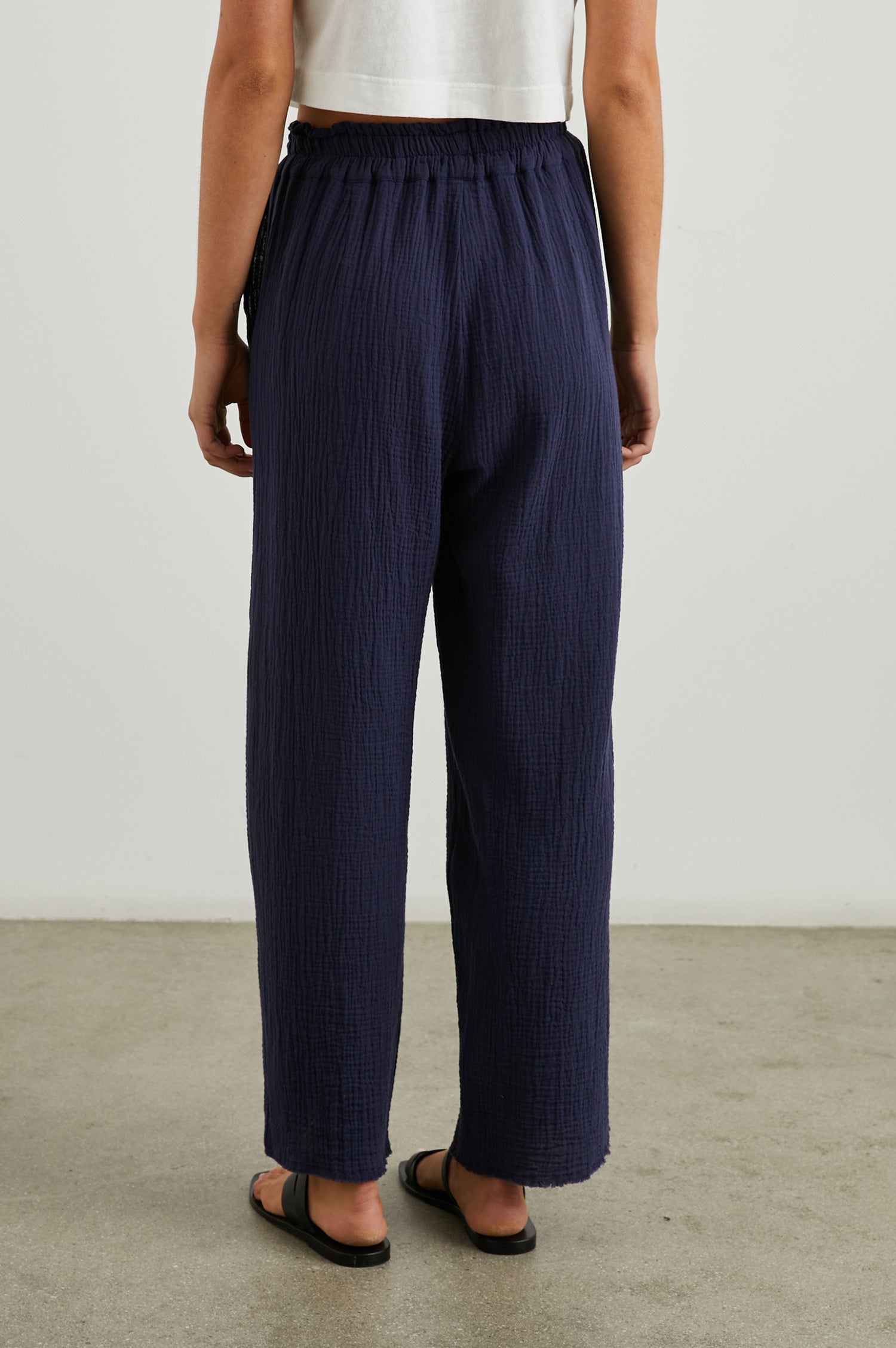 Leon Crop Pant with a Smocked Waistband and Two Front Seam Pockets in Navy Colorway - Back View Featured on Model