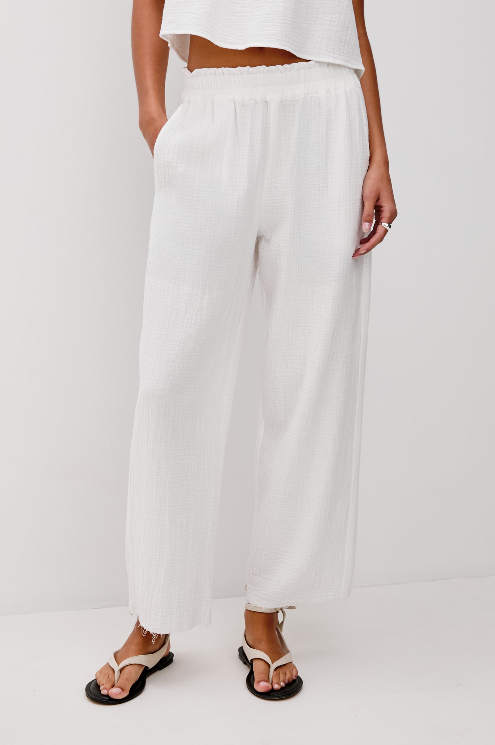 Leon Crop Cotton Gauze Pant With Hemline Slit And Elastic Waist In Colorway White - Front View Featured On Model