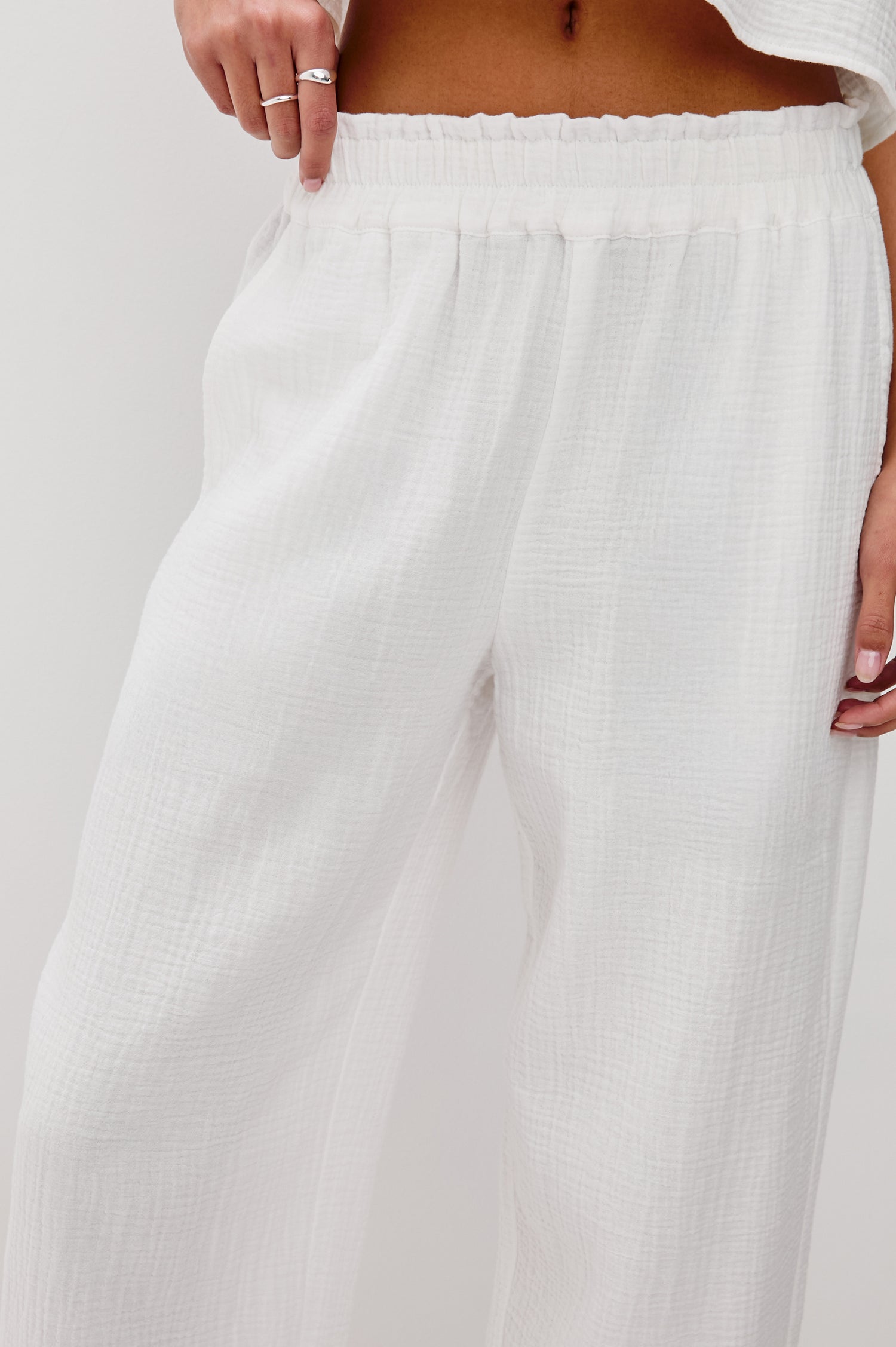 Leon Crop Cotton Gauze Pant With Hemline Slit And Elastic Waist In Colorway White - Front Detail View Featured On Model