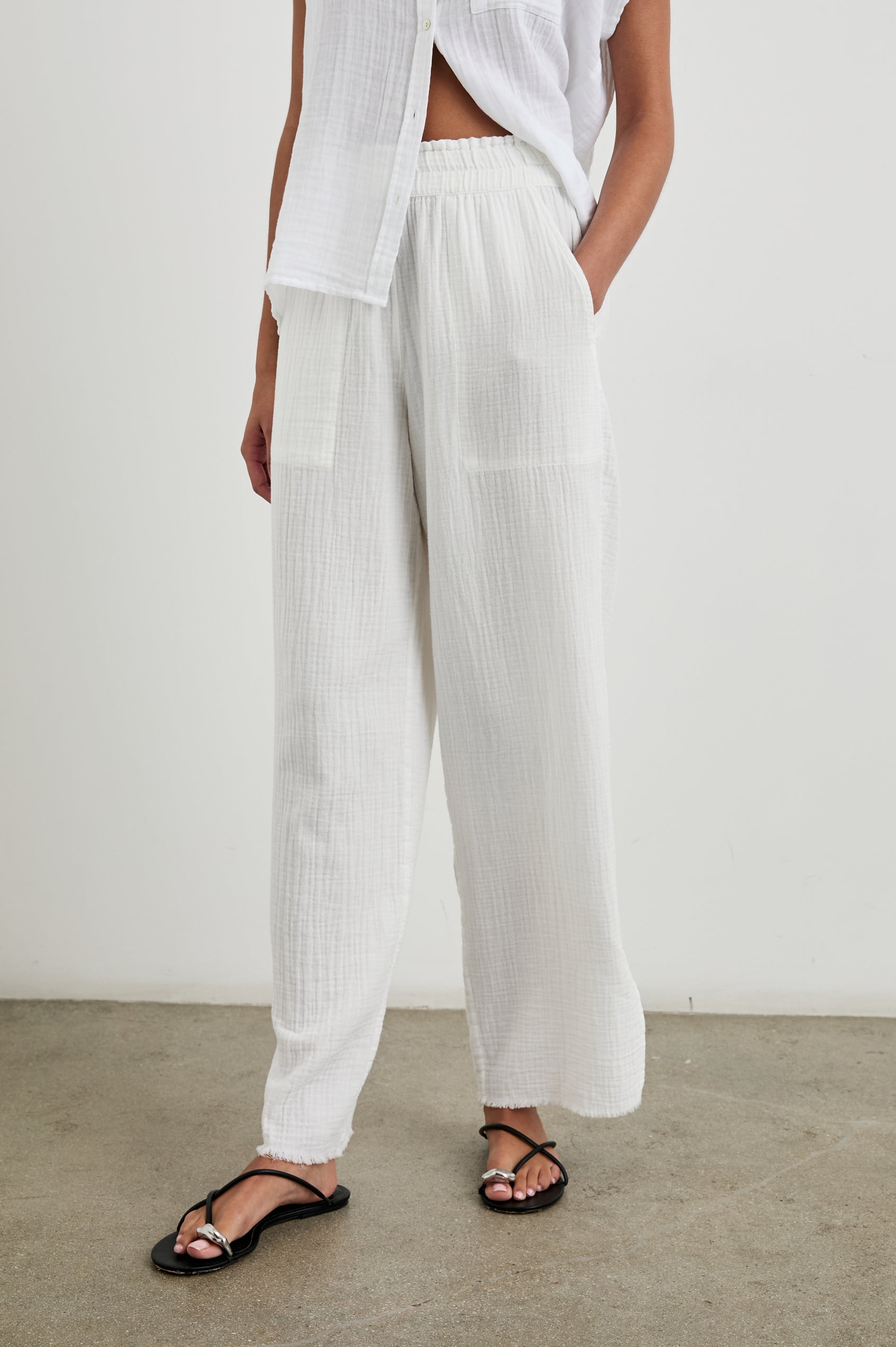 Leon Cotton Gauze Pant With Hemline Slit And Elastic Waist In Colorway White - front view on model, slight angle