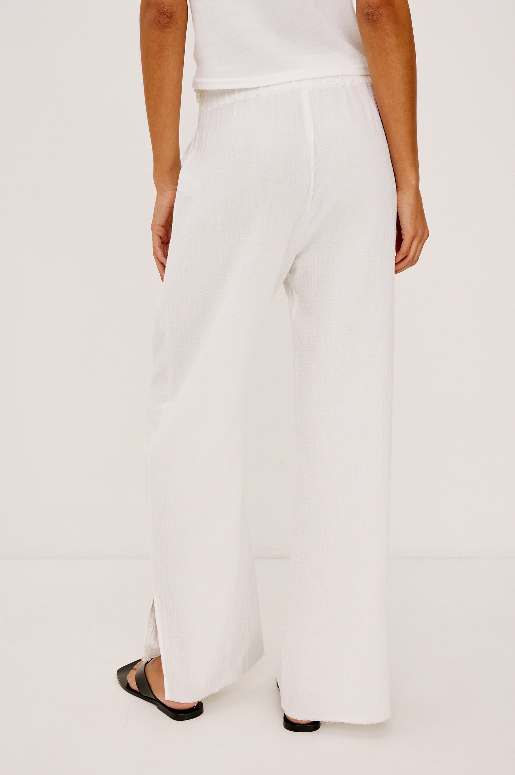Leon Crop Pant in Double Gauze Cotton With Wide Straight Legs, Side Slits, and Smocked Waistband in White Colorway - Lower Body Back View Featured on Model