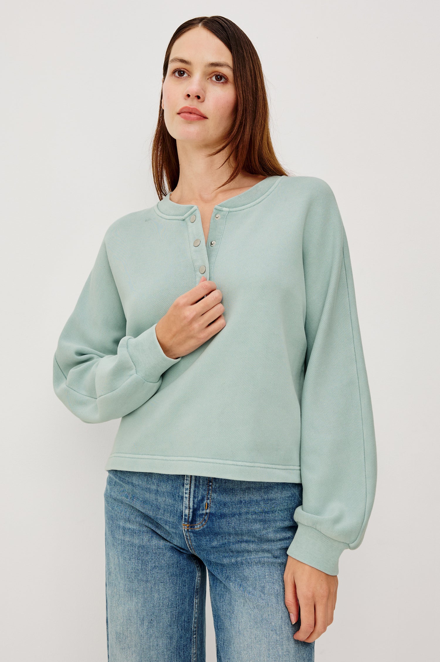 Leonie Sweatshirt in French Terry With Relaxed Boxt Fit, Snap Button Half Placket, Long Puff Sleeves, and Ribbed Neckline and Cuffs in After Midnight Colorway - Upper Body Front View Featured on Model
