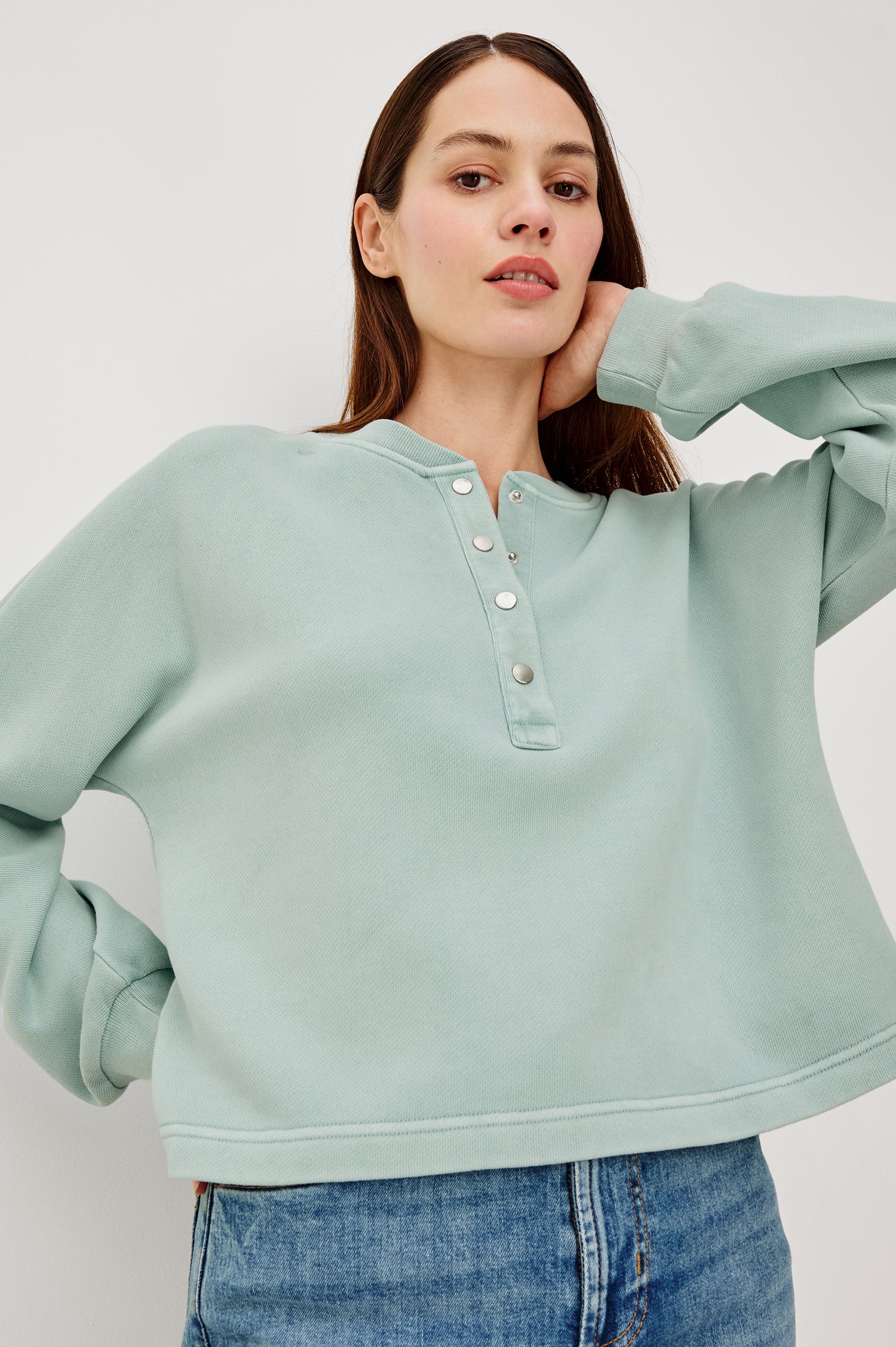 Leonie Sweatshirt in French Terry With Relaxed Boxt Fit, Snap Button Half Placket, Long Puff Sleeves, and Ribbed Neckline and Cuffs in After Midnight Colorway - Upper Body Front View Featured on Model