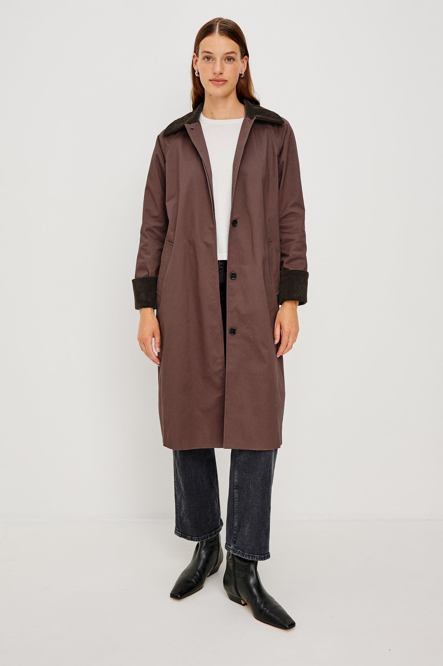 Full-length coat with a classic silhouette in Raisin Colorway. The coat is fully lined in plaid and finished with corduroy accents at the cuffs and collar for a heritage-inspired look. Front View featured on Model.