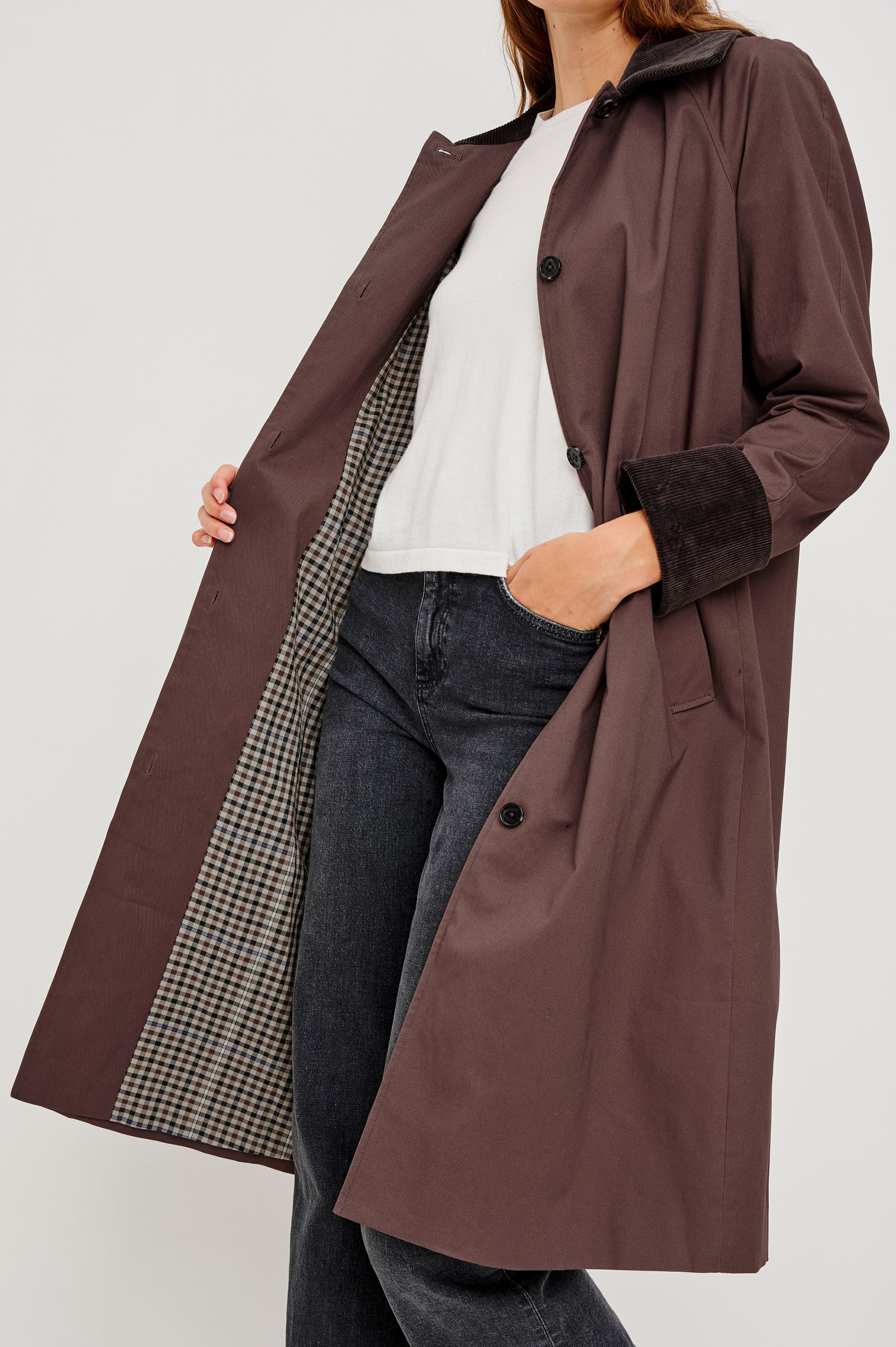 Full-length coat with a classic silhouette in Raisin Colorway. The coat is fully lined in plaid and finished with corduroy accents at the cuffs and collar for a heritage-inspired look. Close Up View featured on Model.