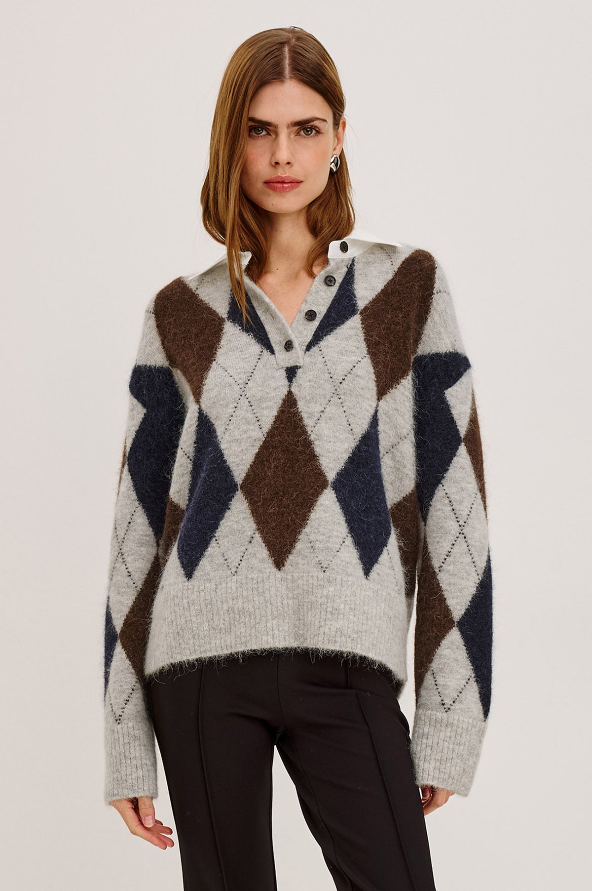 Linda Sweater in Alpaca Blend Knit With Contrast Polo Collar and Button Placket, Slightly Oversized Relaxed Fit, and Ribbed Trim in Cedar Argyle Colorway - Upper Body Front View Featured on Model.