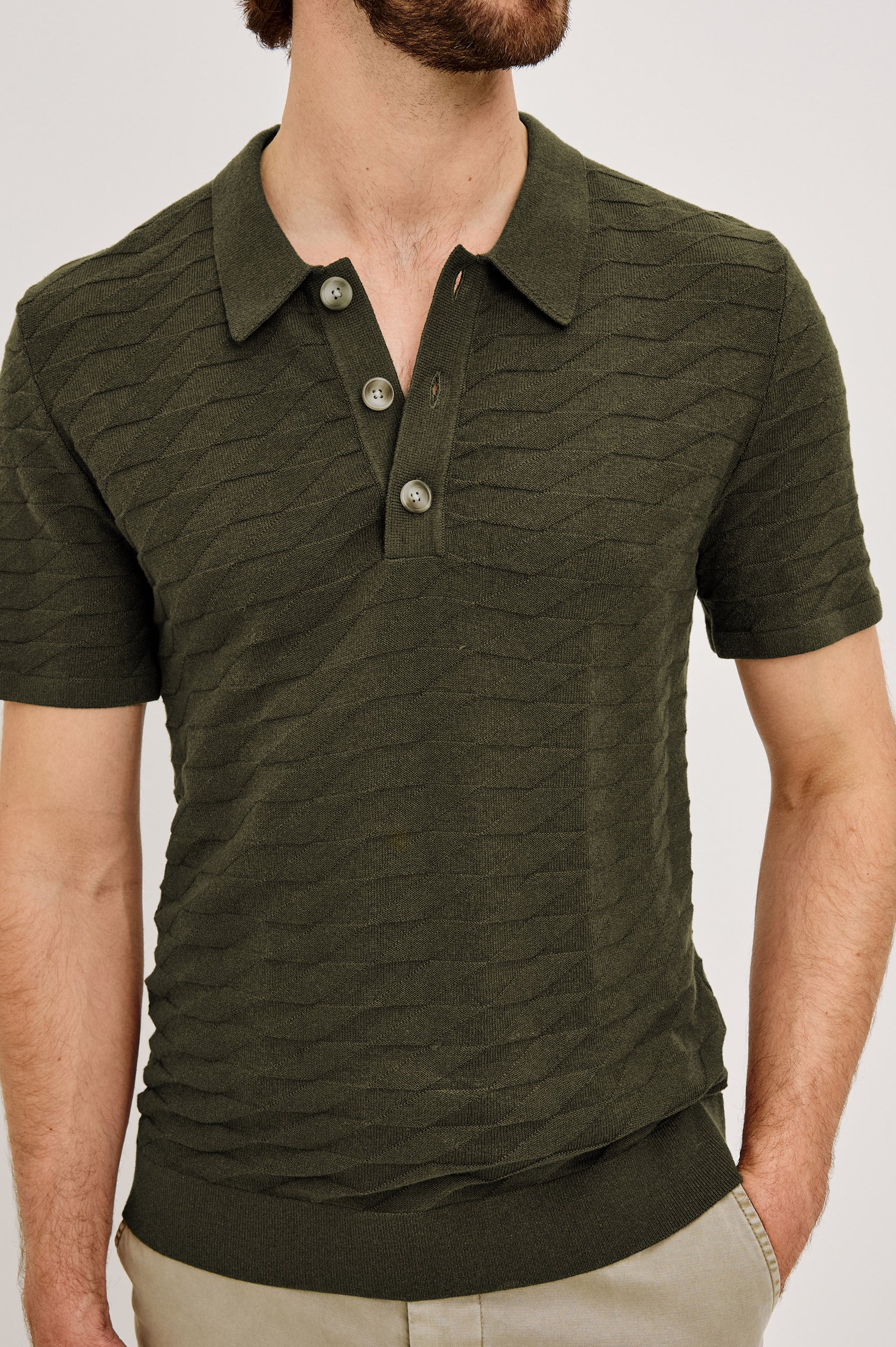 Linden Polo Shirt in Cotton Knit With Subtle Diamond Texture, Classic Fit, Quarter Button Placket, Short Sleeves, and Ribbed Trim in Ancient Olive Prism Colorway - Upper Body Front View Featured on Model