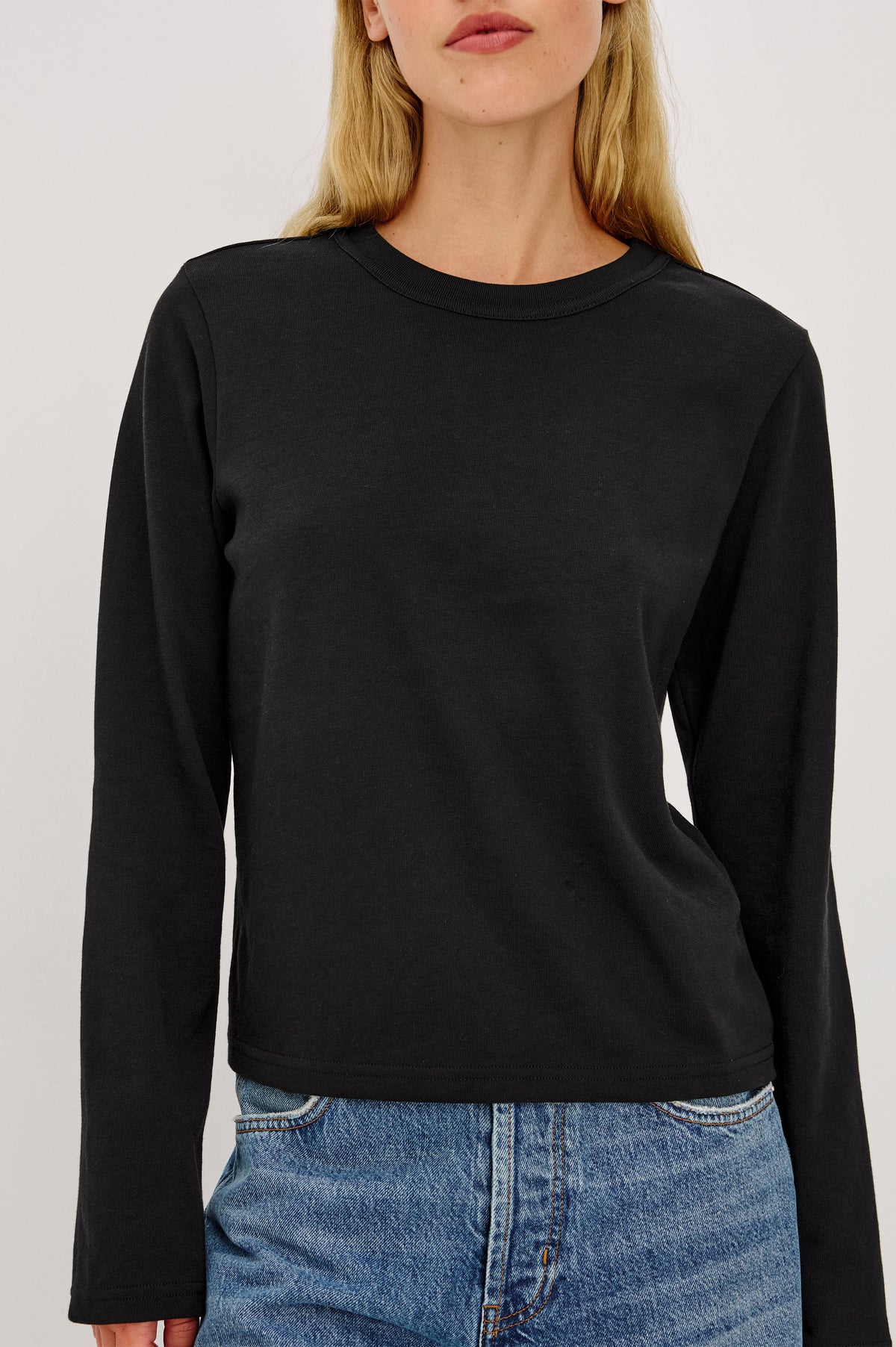 Long Sleeve Girlfriend Tee in Midweight Pleated Jersey in Slightly Boxy Cropped Fit With Crew Neckline in Black Colorway - Front Crop Detail View Featured on Model.