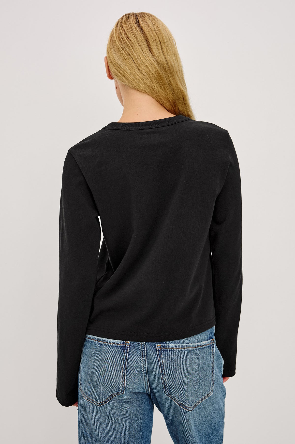 Long Sleeve Girlfriend Tee in Midweight Pleated Jersey in Slightly Boxy Cropped Fit With Crew Neckline in Black Colorway - Back Crop View Featured on Model.