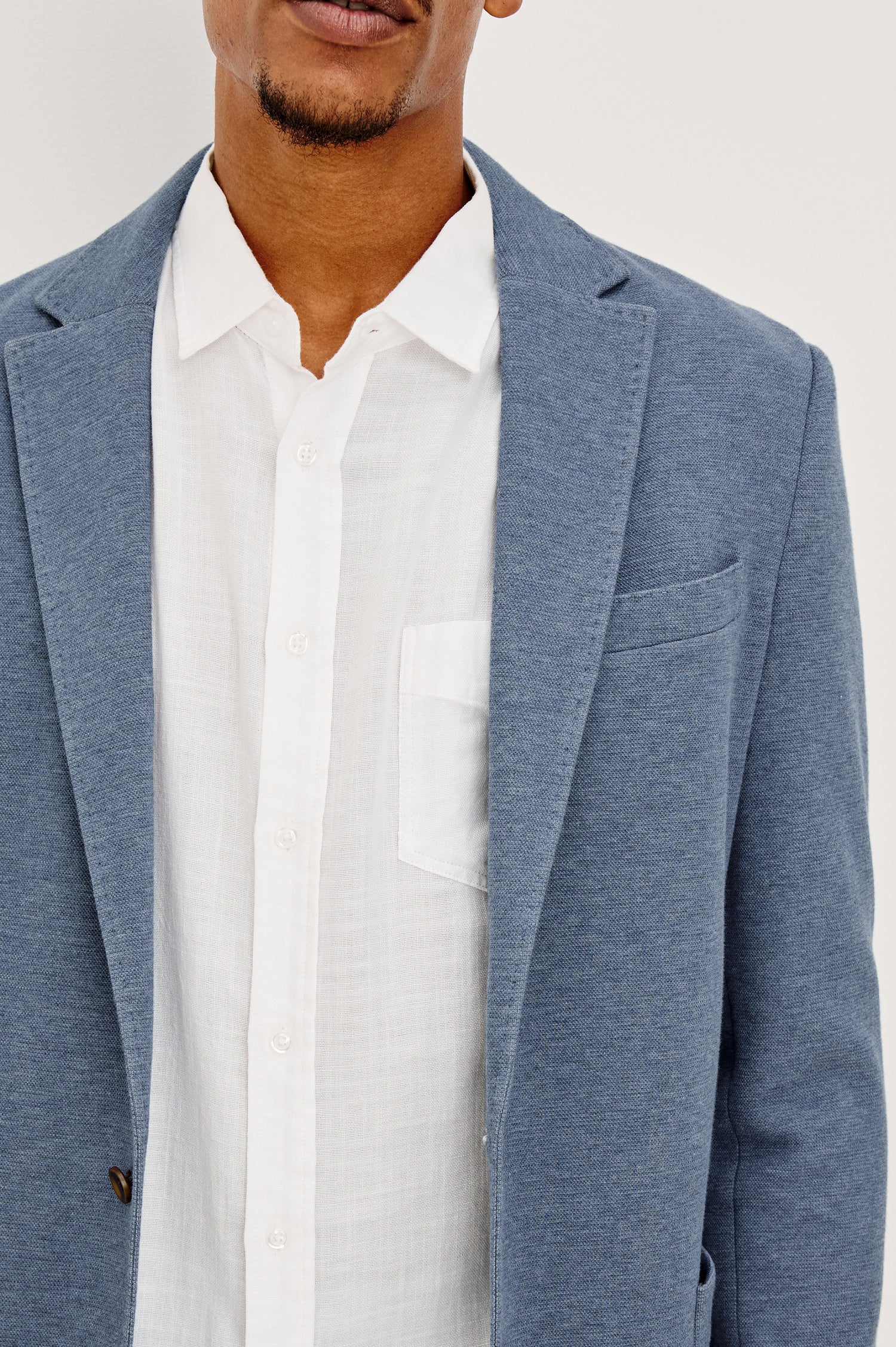 Lorenz Blazer in Nylon With Single Breasted Front Buttons, Single Chest Patch Pocket, Side Patch Pockets, and Long Sleeves in Heather Blue Colorway - Close up Front View Featured on Model