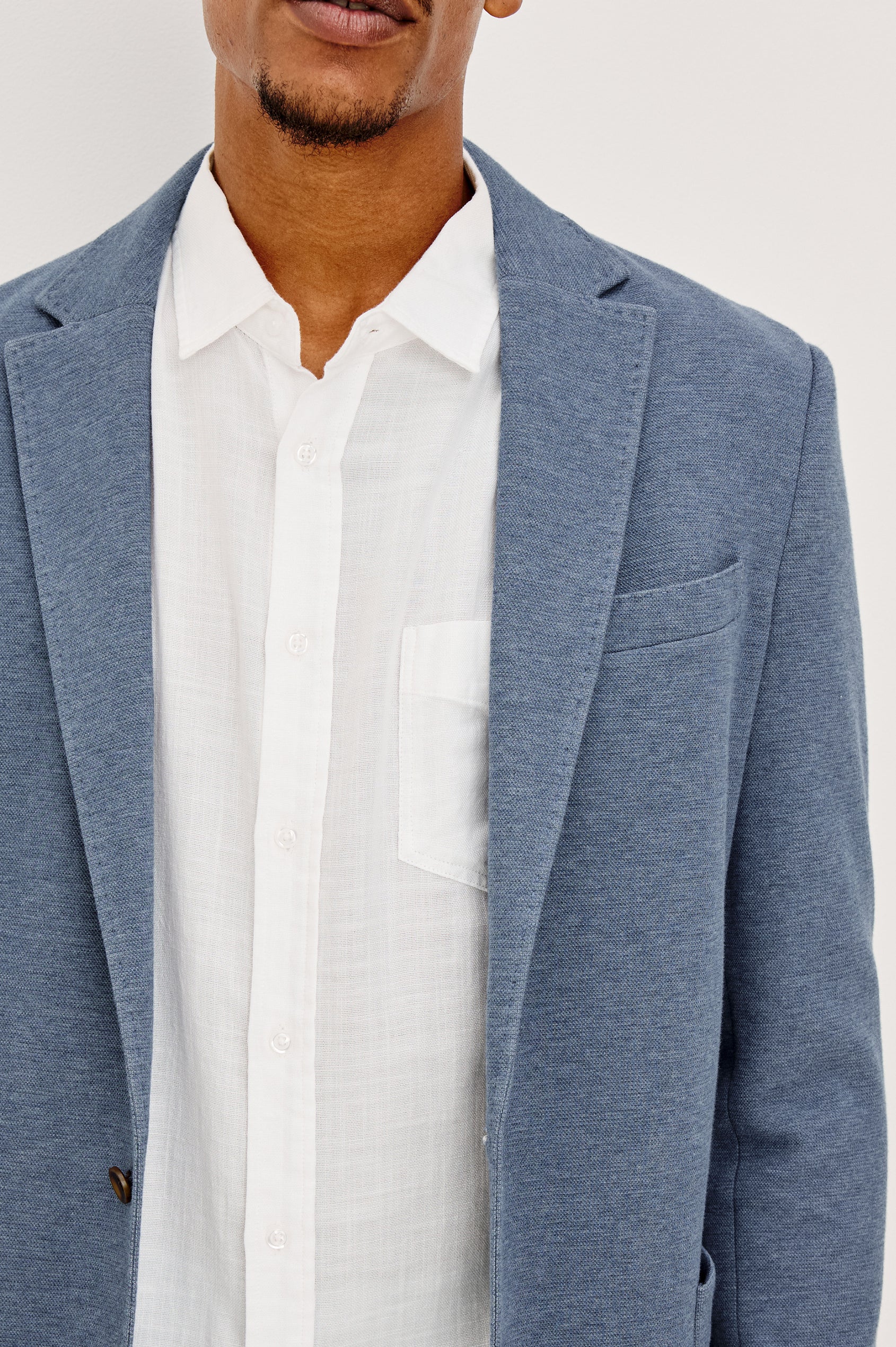 Lorenz Blazer in Nylon With Single Breasted Front Buttons, Single Chest Patch Pocket, Side Patch Pockets, and Long Sleeves in Heather Blue Colorway - Close up Front View Featured on Model