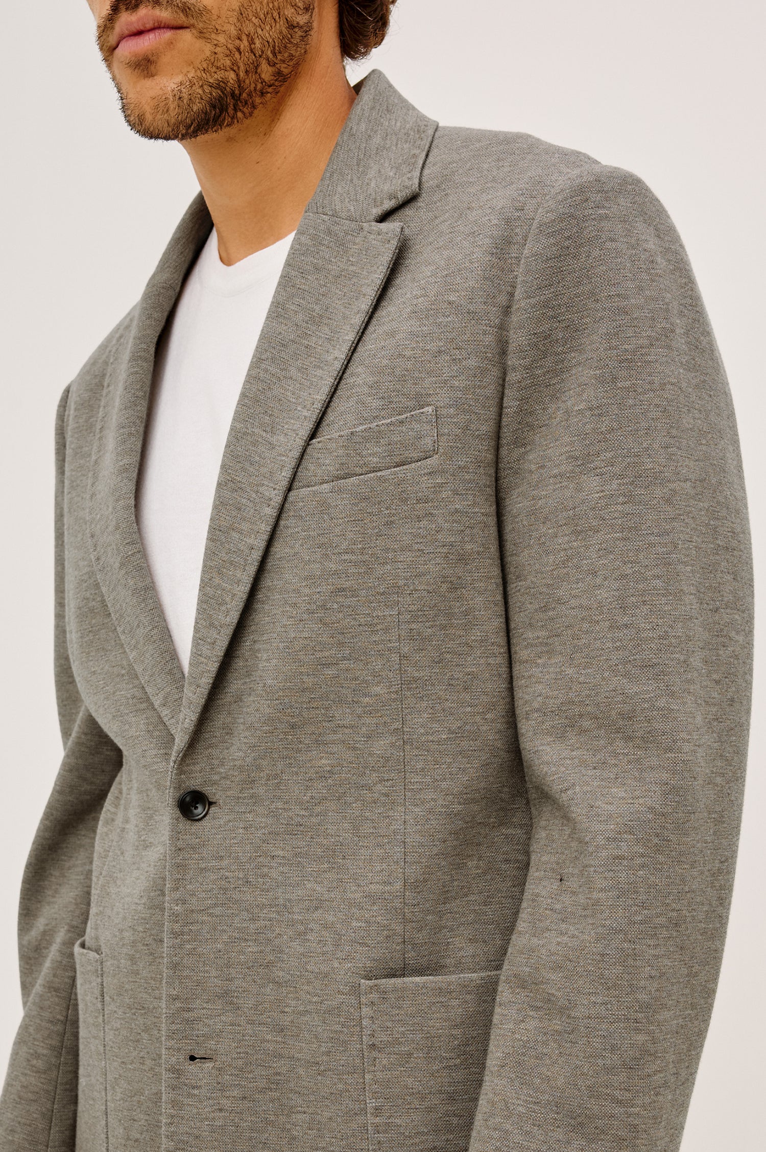 Lorenz Blazer in Ponte Jersey With Single-Breasted Design, Relaxed Fit, Jersey Lining, Notched Lapels, Chest Welt Pocket, Side Patch Pockets, Button-Cuff Long Sleeves, and Double Back Vents in Walnut Heather Colorway - Upper Body Front View Featured on Model