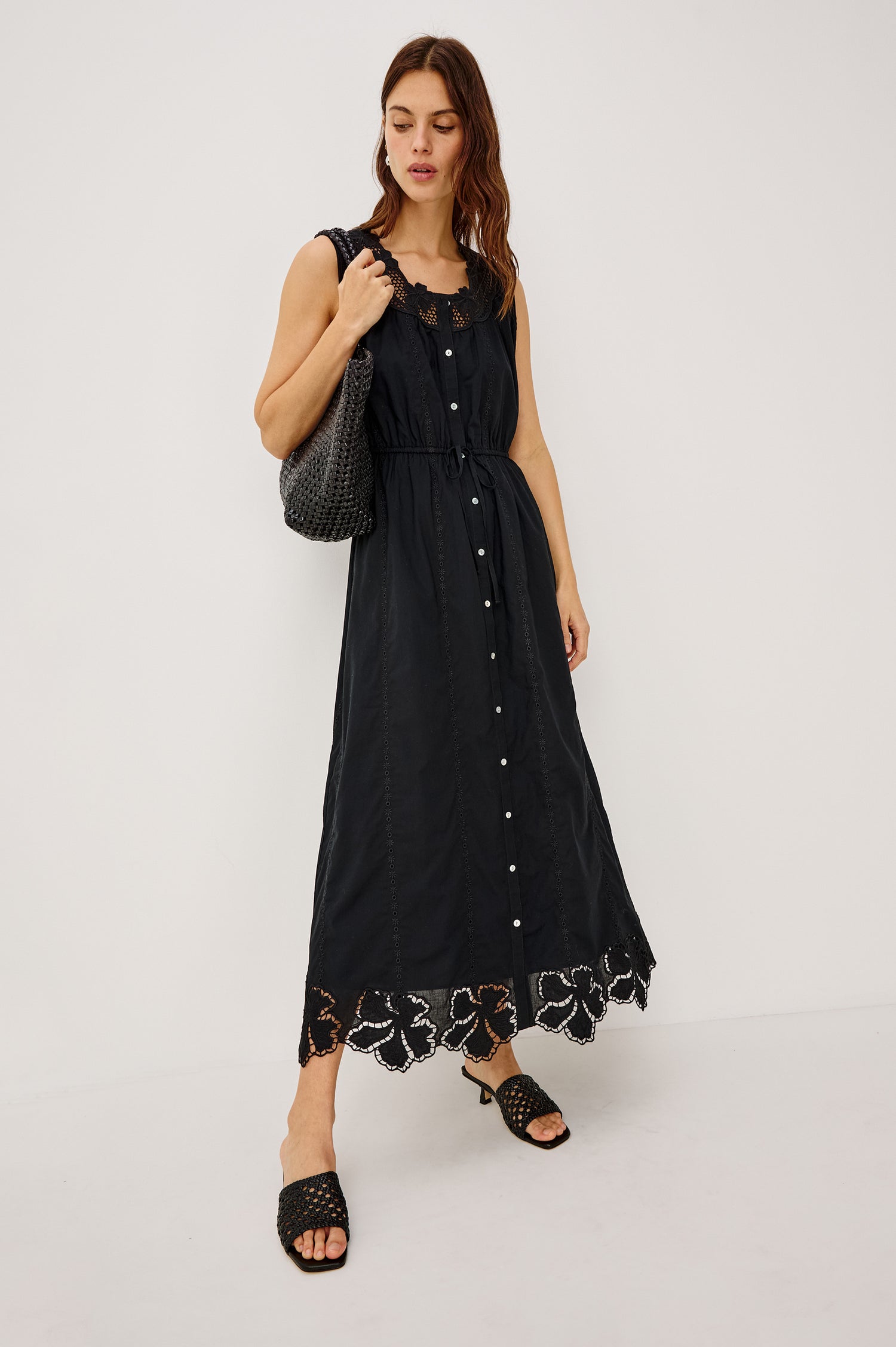 Lorina Midi Dress in Cotton Voile With Lattice and Floral Embroidery, Sleeveless Cut, and Adjustable Waist Ties in Black Colorway - Full Body Front View Featured on Model