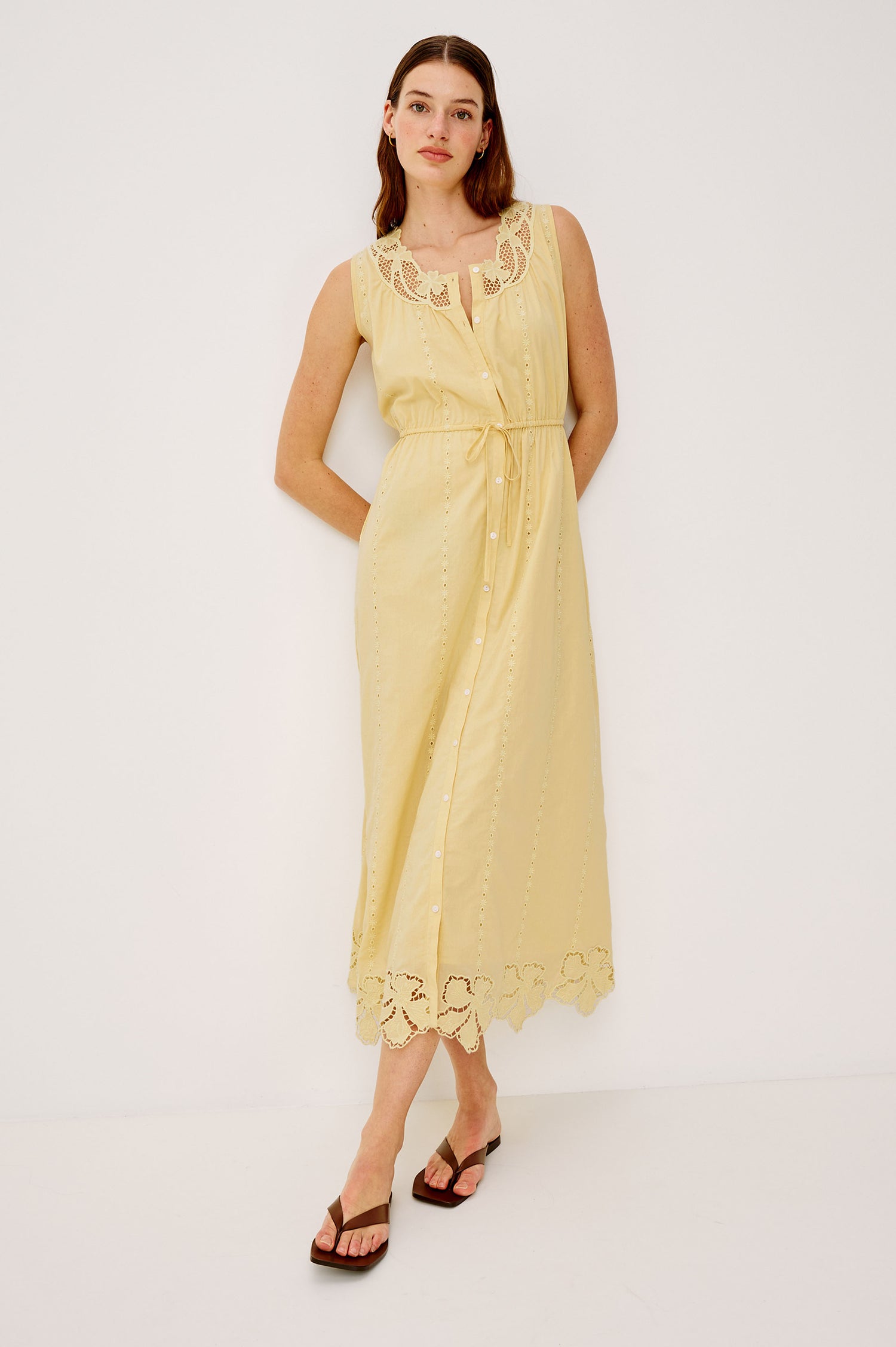 Lorina Midi Dress in Beach Cottton With Lattiice and Floral Embroidery, Sleeveless Cut, and Adjustable Waist Ties in Sunshine Colorway - Full Body Front View Featured on Model