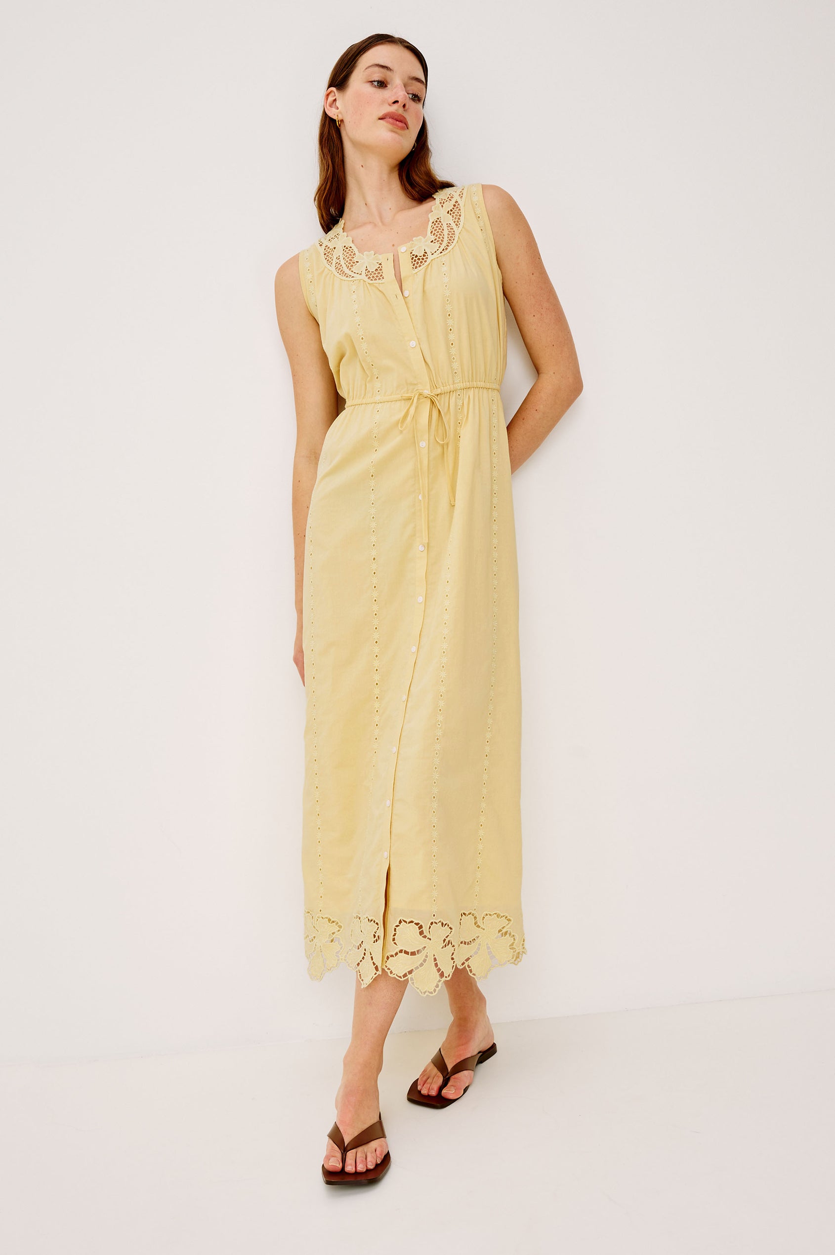Lorina Midi Dress in Beach Cottton With Lattiice and Floral Embroidery, Sleeveless Cut, and Adjustable Waist Ties in Sunshine Colorway - Full Body Front View Featured on Model