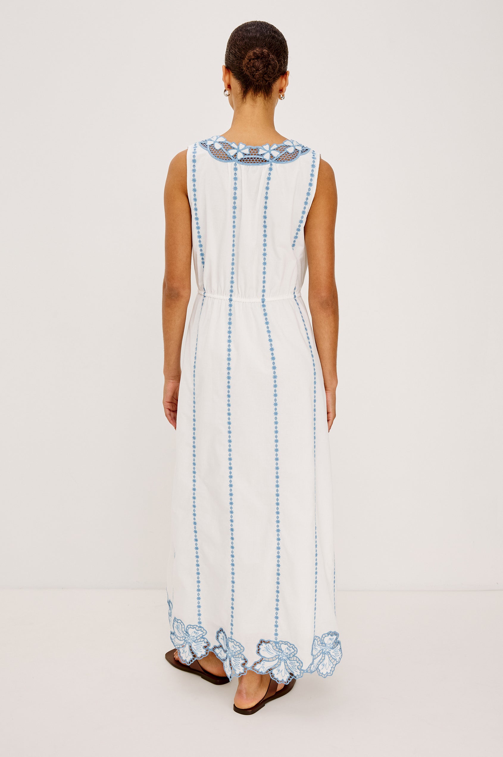 Lorina Midi Dress in Cotton Voile With Contrast Lattice and Floral Embroidery, Sleeveless Cut, and Adjustable Waist Ties in White Colorway - Full Body Back View Featured on Model
