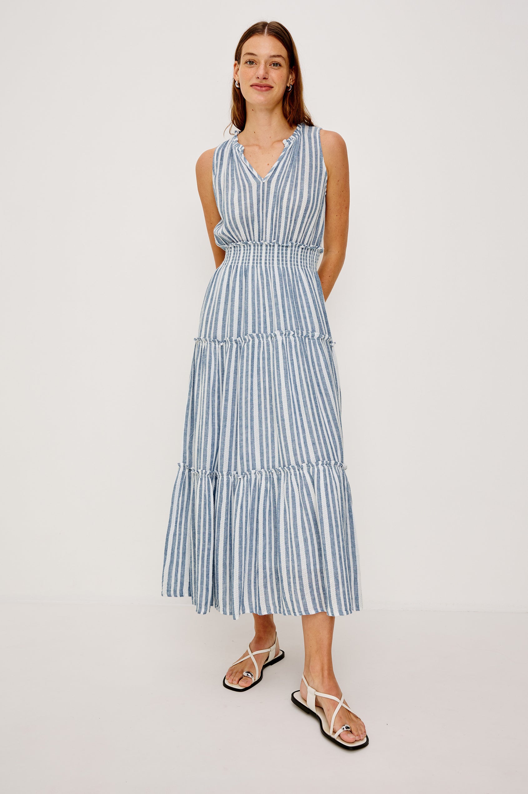Loulou V-Neck Midi Dress with Smocked Elastic Waistband and a Multi Tiered Skirt in Blue/White Jalisco Stripe Colorway. Full Body Front View Shown on Model.