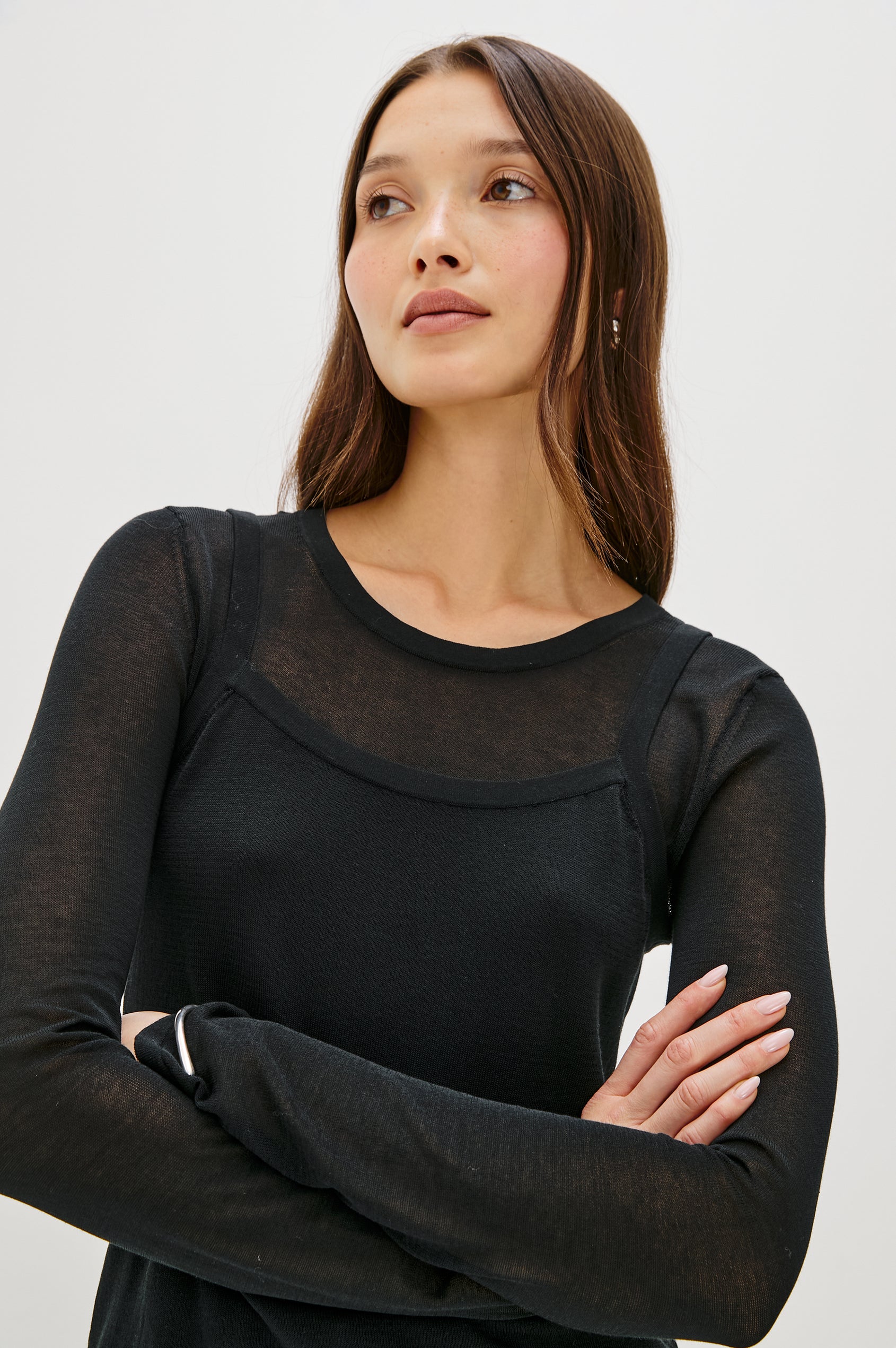 Lovisa is a cotton top designed with a layered look, featuring a lightweight tank underneath a long-sleeve crewneck in Black Colorway. The tonal pairing creates built-in dimension with a casual, modern feel. Close up of Details featured on model.