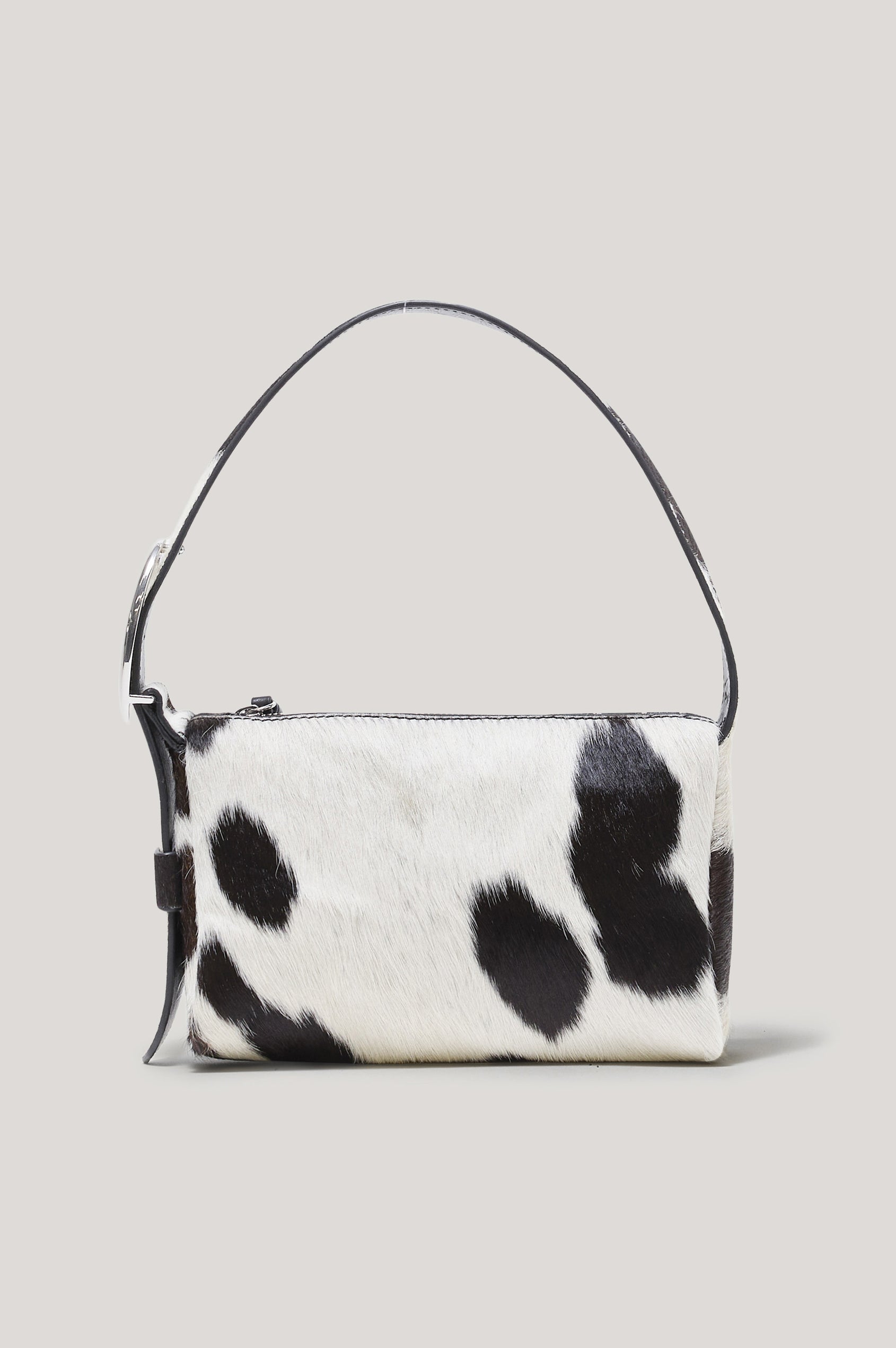 The Lucca is a long-hair cowhide shoulder bag with an adjustable strap and polished silver oval buckle. In Cowgirl Haircalf colorway. Front view featured.