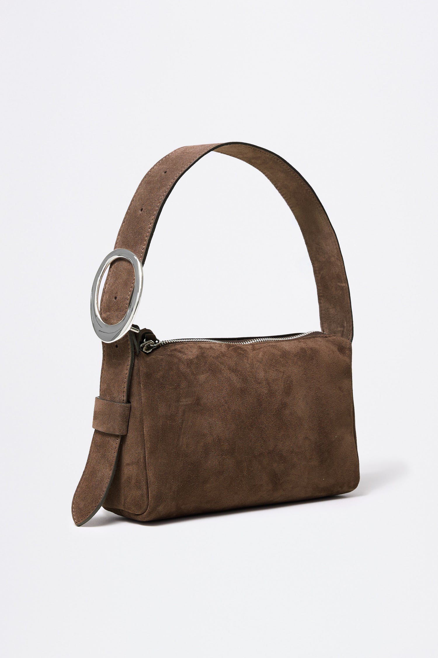 The Lucca is a smooth suede shoulder bag with an adjustable strap and polished silver oval buckle. In Espresso Suede colorway. Front angeled view featured.