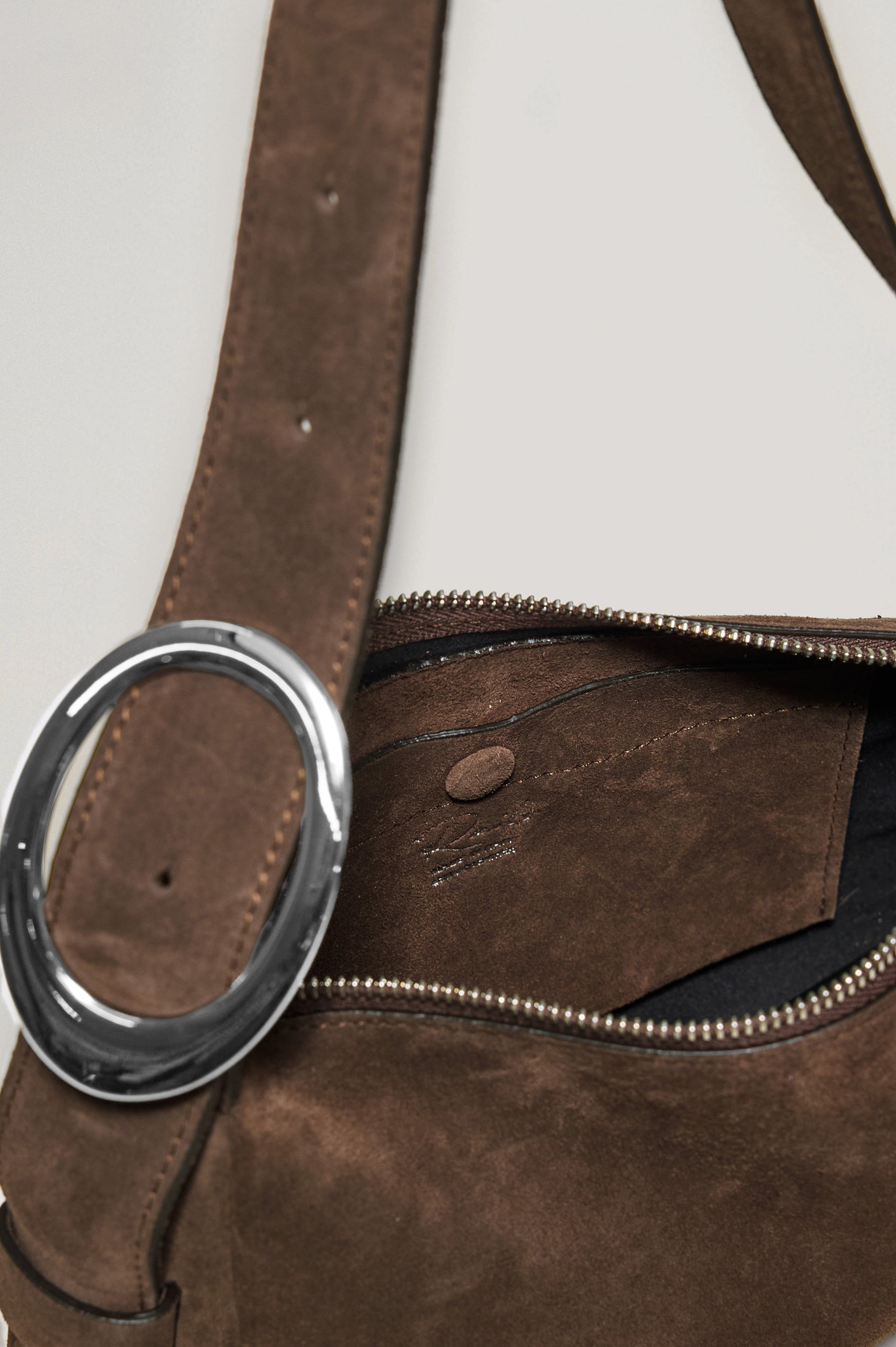 Lucca Shoulder Bag in Suede With Adjustable Strap and Polished Silver Buckle, Microsuede Lining, and Snap Button Interior Slip Pocket in Espresso Suede Colorway - Side View Close Up Featured